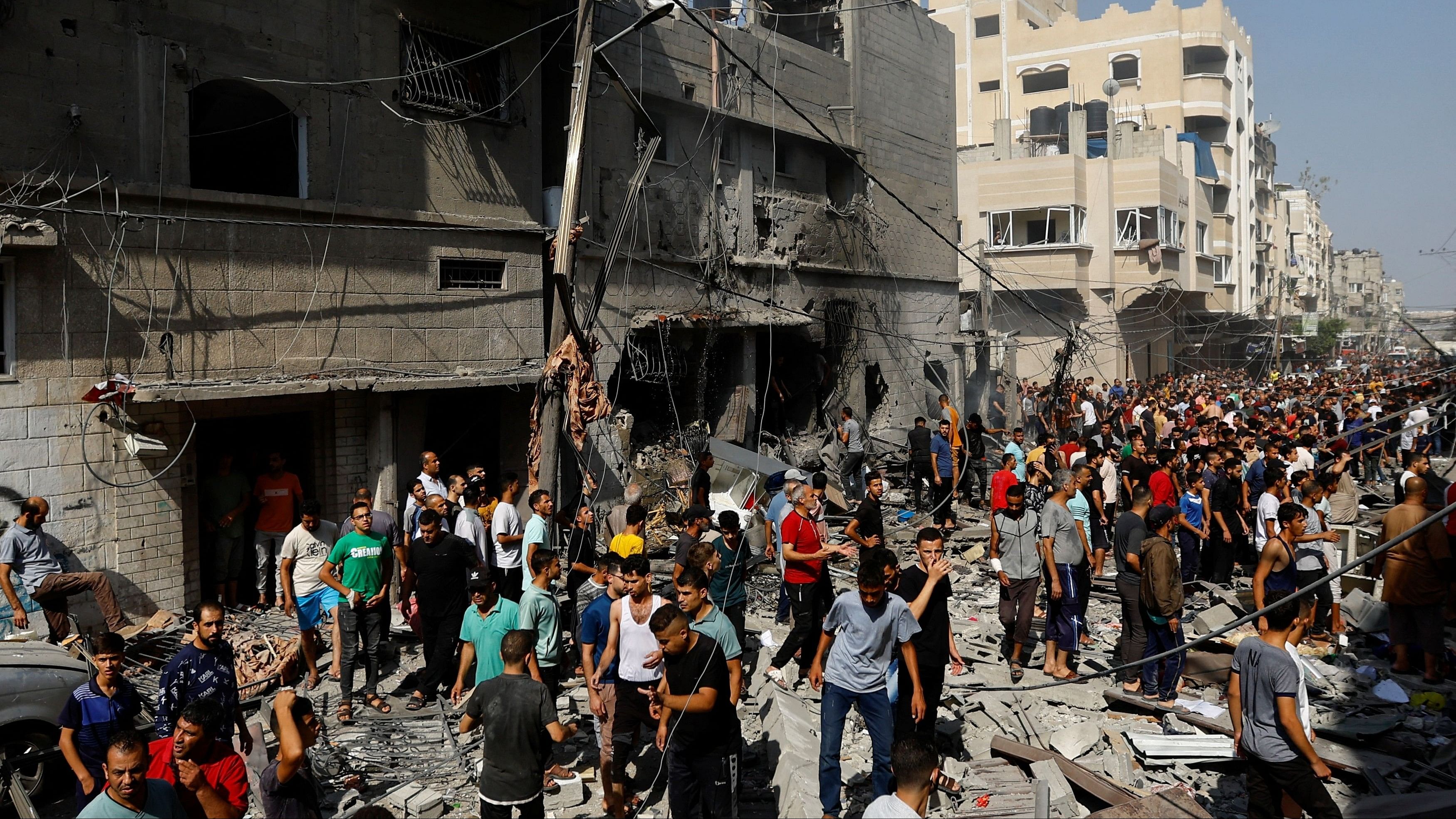 <div class="paragraphs"><p>People gather at the site of an Israeli strike on a house, in Khan Younis, in the southern Gaza Strip, October 24, 2023. </p></div>