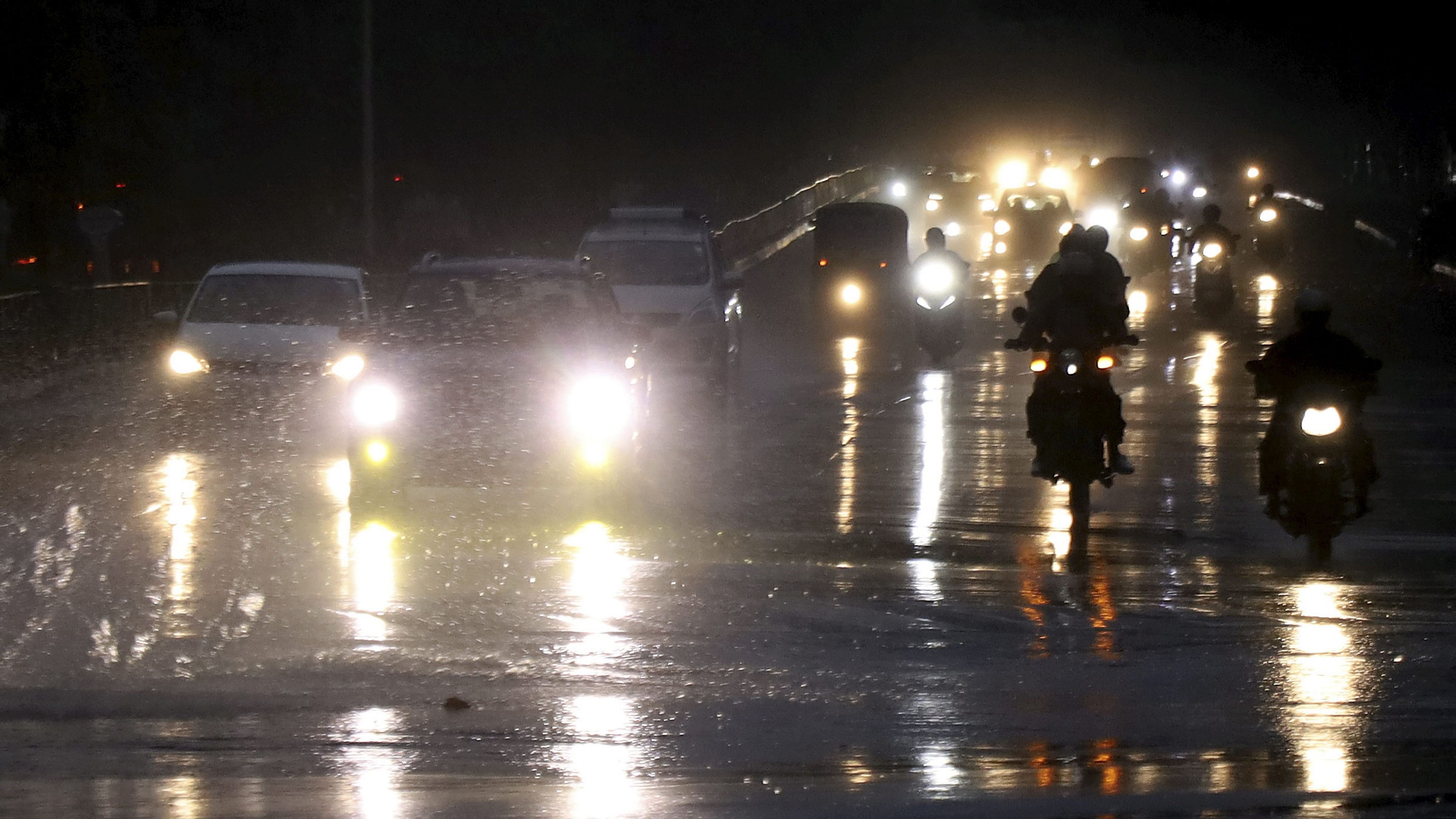 <div class="paragraphs"><p>Vehicles move on a road amid rain in Bengaluru.&nbsp;</p></div>