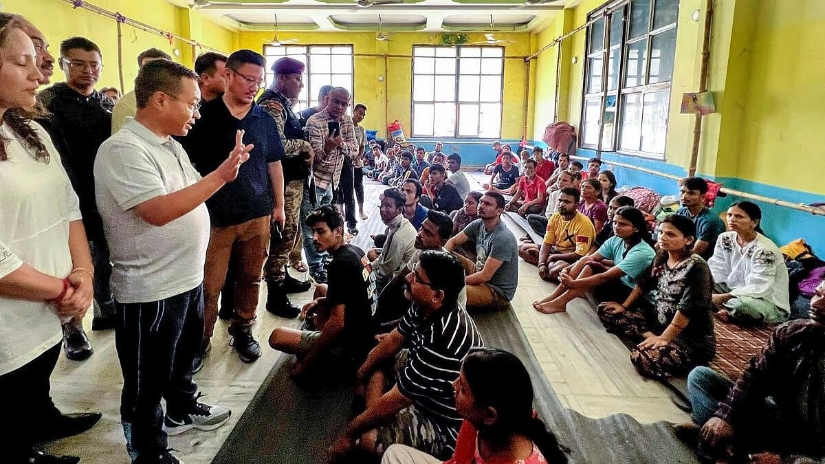 <div class="paragraphs"><p>Sikkim Chief Minister Prem Singh Tamang interacts with flood-affected people following a cloudburst in Sikkim, on Friday, Oct. 6, 2023.</p></div>