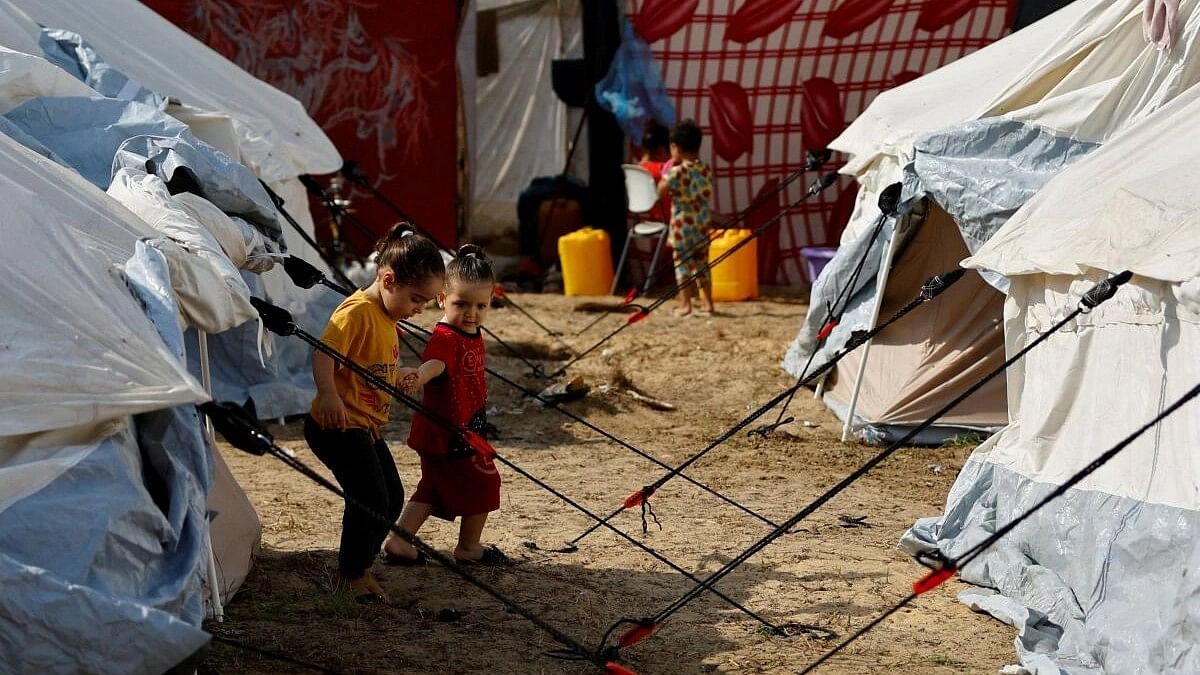 <div class="paragraphs"><p>Displaced Palestinian kids, who fled their houses amid Israeli strikes, take shelter in a tent camp at a United Nations-run centre, after Israel's call for more than 1 million civilians in northern Gaza to move south, in Khan Younis in the southern Gaza Strip, October 24, 2023.</p></div>