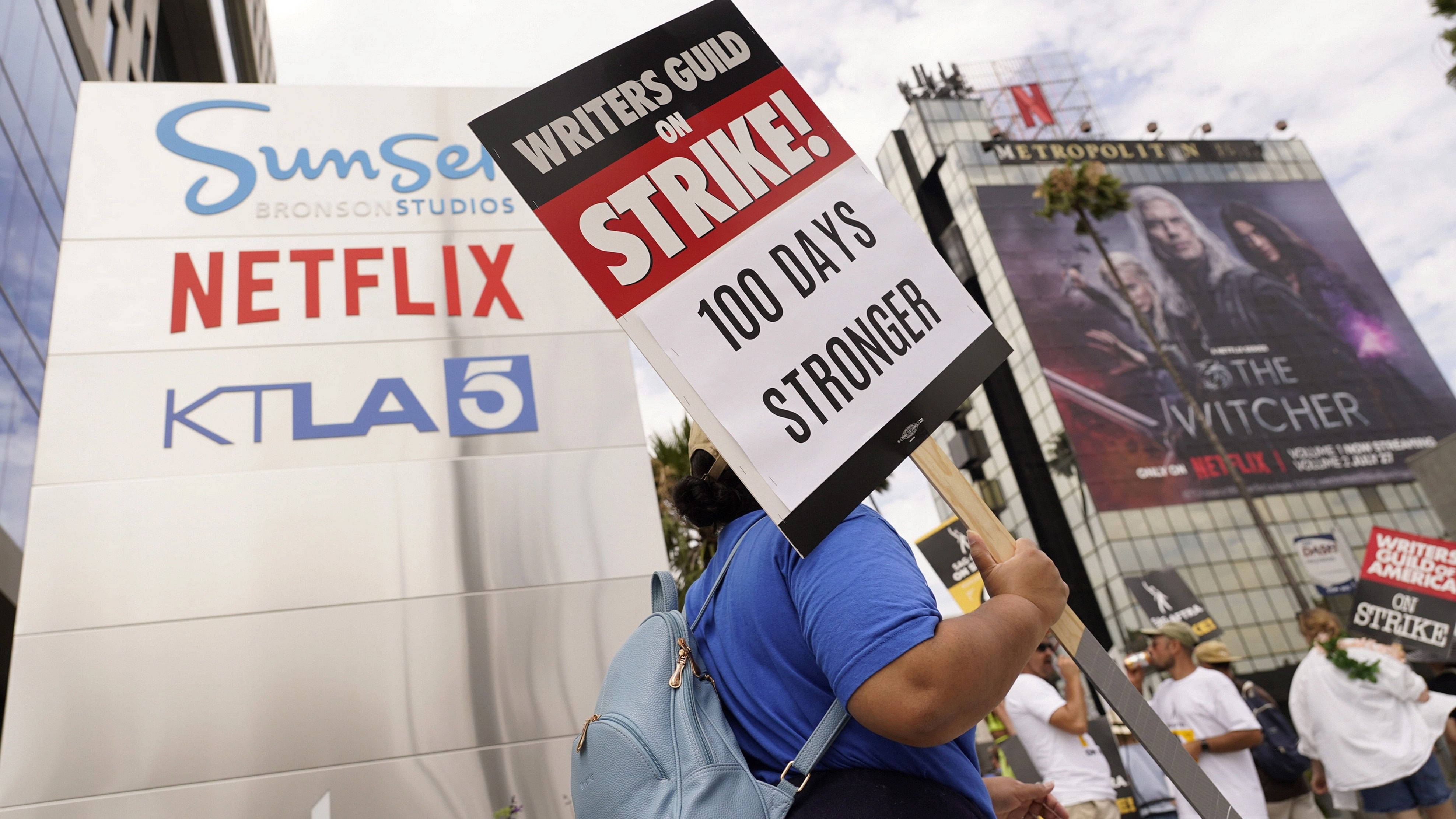 <div class="paragraphs"><p>A picketer carries a sign outside Netflix studios.</p></div>