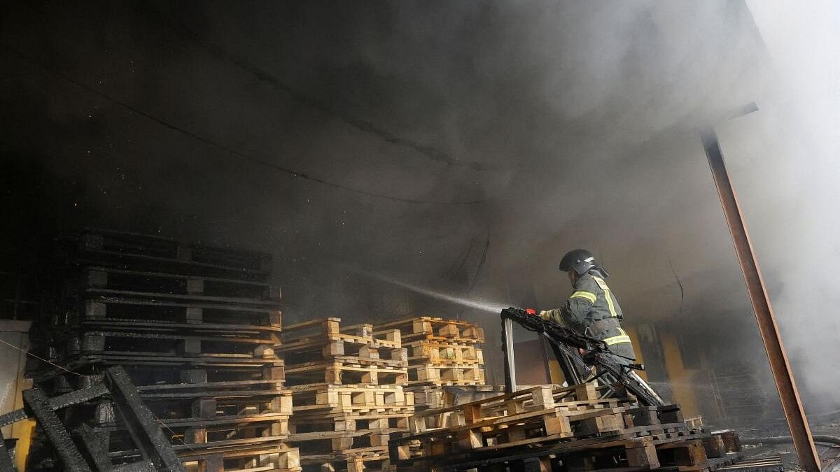 <div class="paragraphs"><p>A firefighter works to put out fire at a warehouse that was hit by shelling in the course of Russia-Ukraine conflict in Donetsk, Russian-controlled Ukraine</p></div>