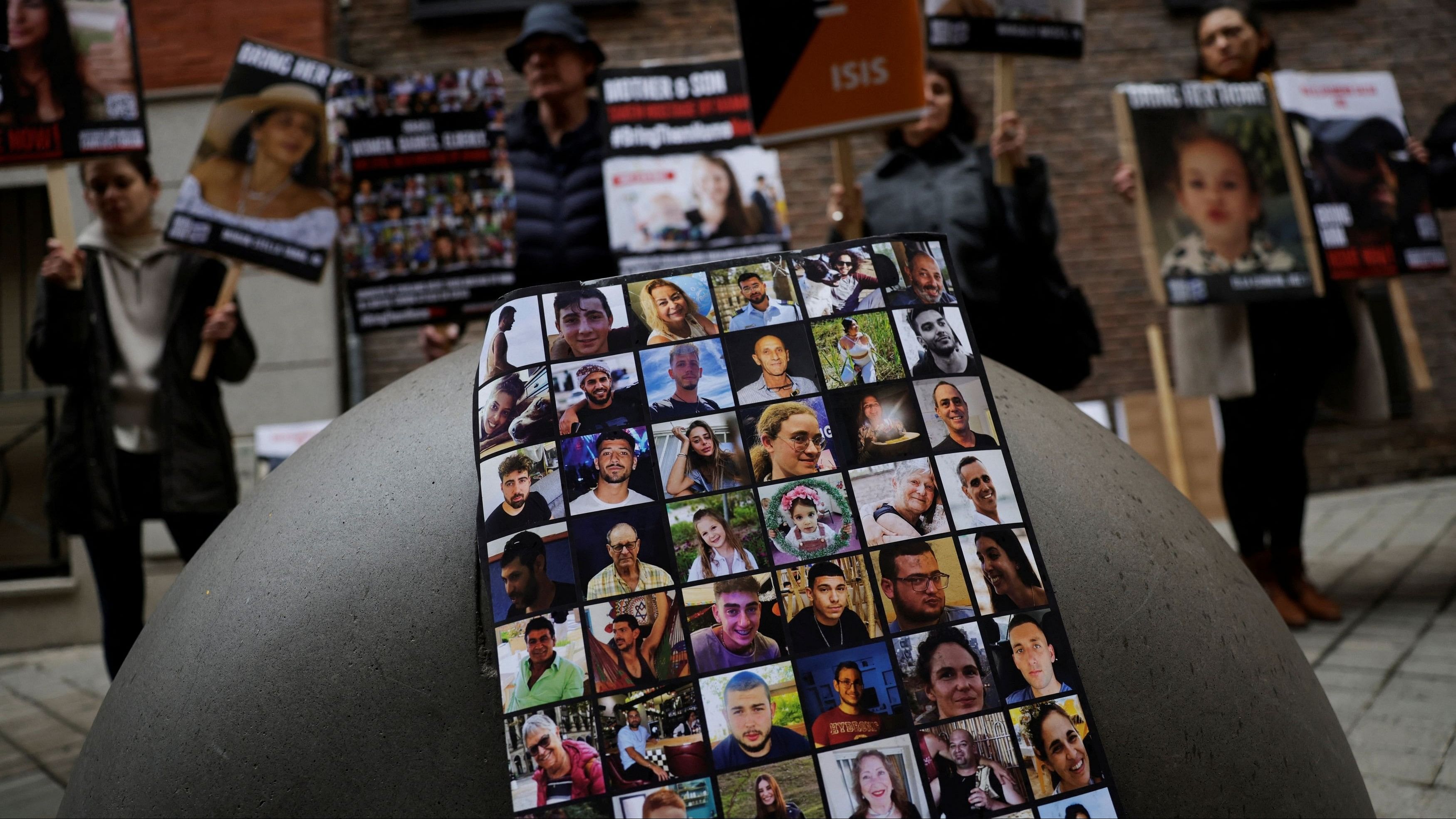 <div class="paragraphs"><p>People hold placards with pictures of Israelis believed to be held hostage by Hamas militants in the Gaza Strip, prior to a press conference with family members of hostages, amid the ongoing conflict between Israel and the Palestinian Islamist group Hamas, in Madrid, Spain, October 26, 2023.</p></div>