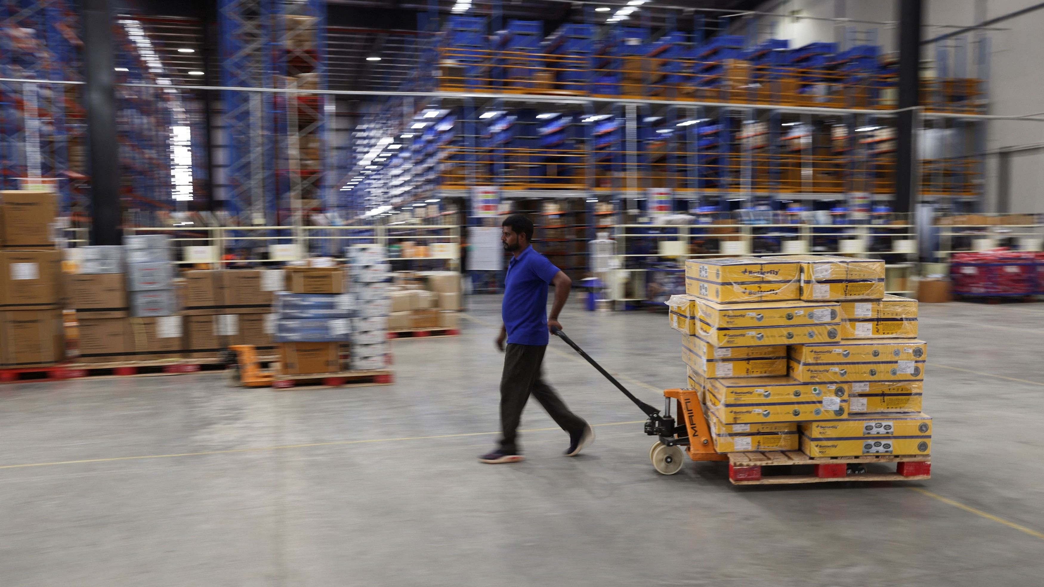 <div class="paragraphs"><p>A man drags a pallet loaded with boxes at the supply management company Prozo's distribution warehouse near Gurugram, India, August 9, 2023. </p></div>