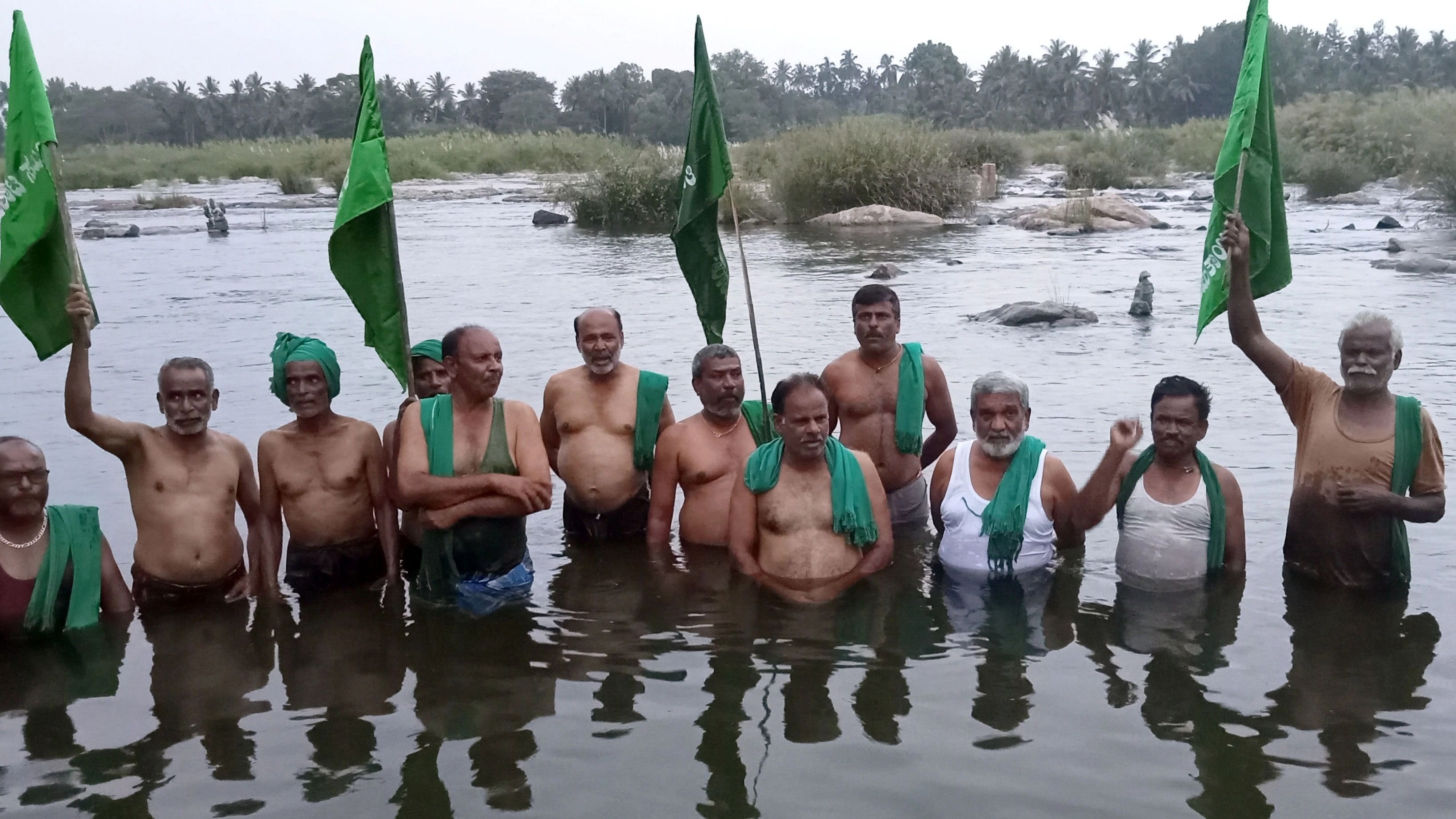 <div class="paragraphs"><p>Members of Bhoomithayi Horata Samiti stage a protest standing semi-nude in river Cauvery near Sopanakatte in Srirangapatna Mandya district on Monday as mark of protest.</p></div>