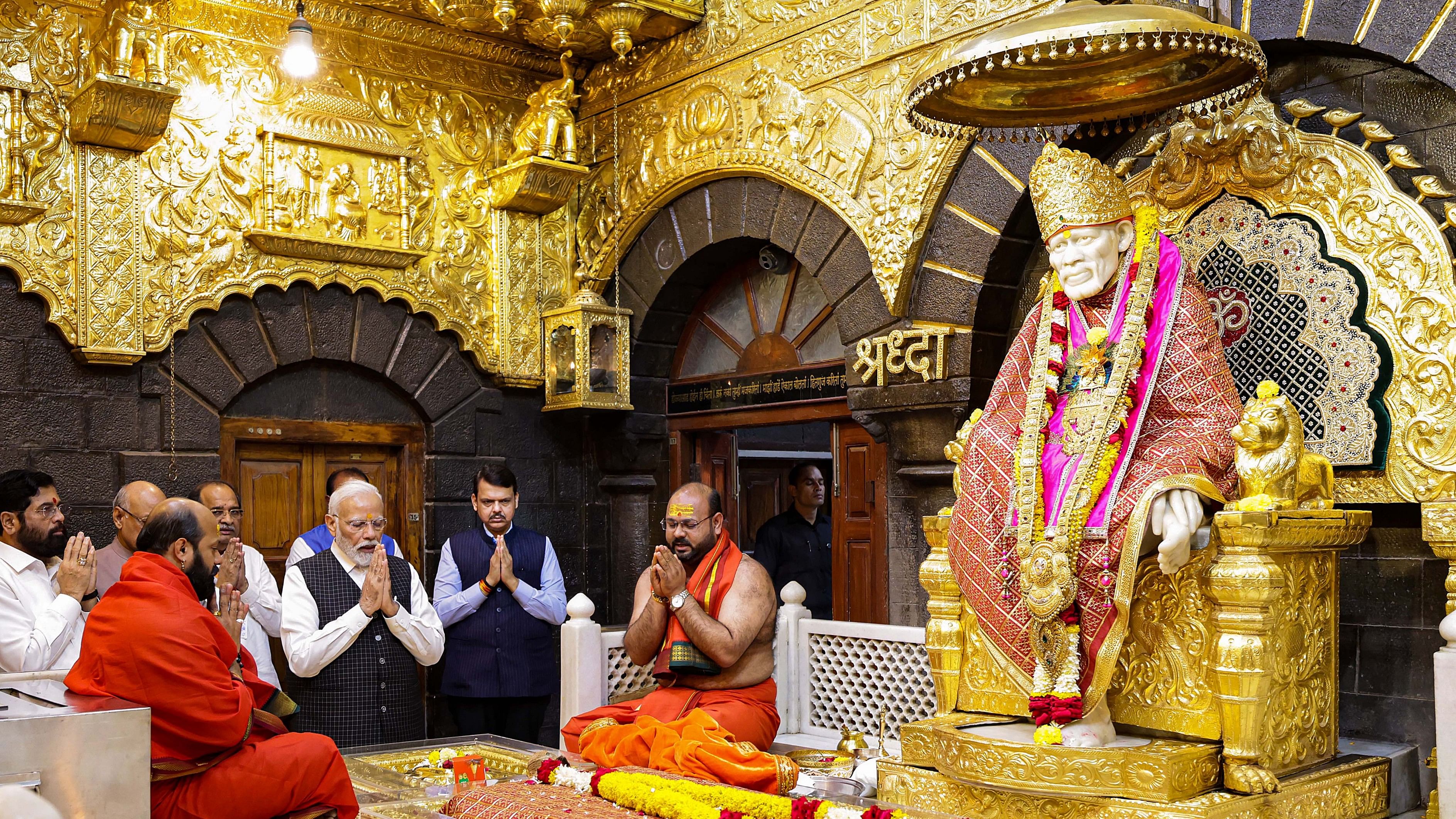 <div class="paragraphs"><p>PM Narendra Modi with Maharashtra Governor Ramesh Bais, Maharashtra Chief Minister Eknath Shinde and Deputy Chief Minister Devendra Fadnavis offers prayers at Shri Saibaba Samadhi Temple, in Shirdi.</p></div>