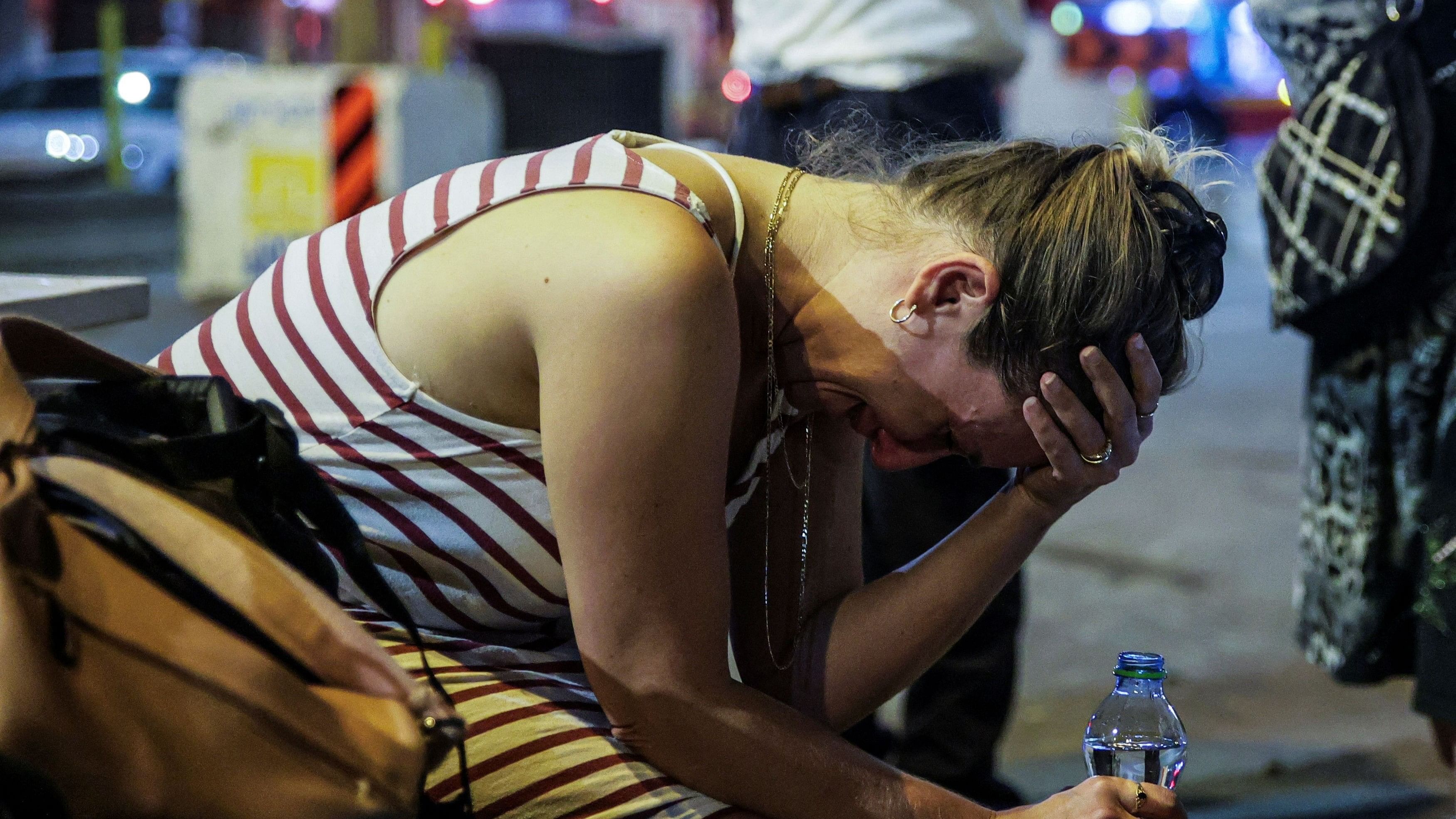 <div class="paragraphs"><p>A woman reacts at the site where a rocket launched from the Gaza Strip landed in Tel Aviv, Israel.</p></div>