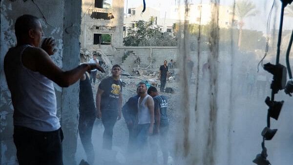 <div class="paragraphs"><p>Palestinians look at the destruction of a house in the aftermath of a strike amid the conflict with Israel in Khan Younis, in the southern Gaza Strip.</p></div>