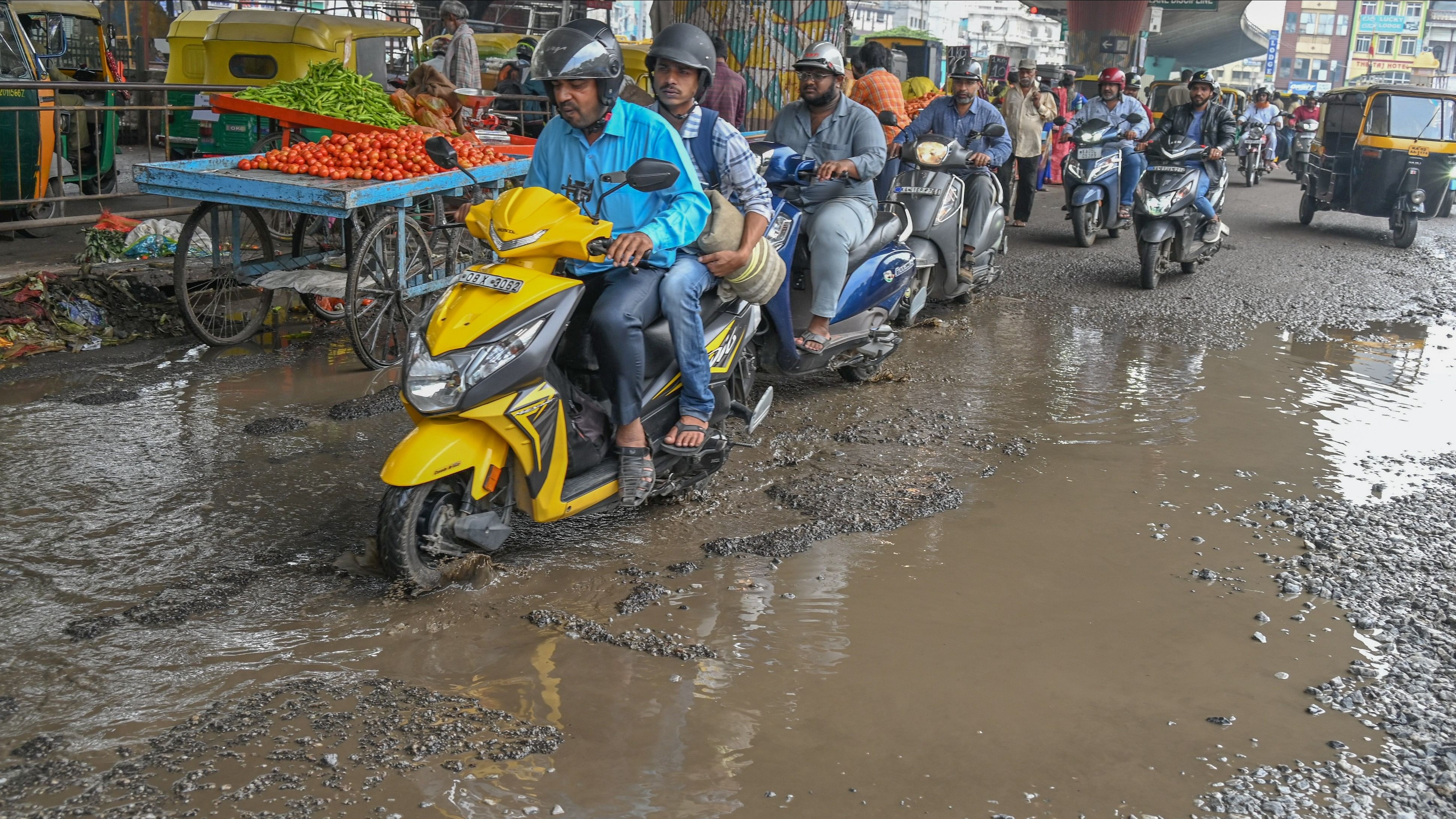 <div class="paragraphs"><p>Commuters navigate a pothole-ridden road near KR Market. </p></div>