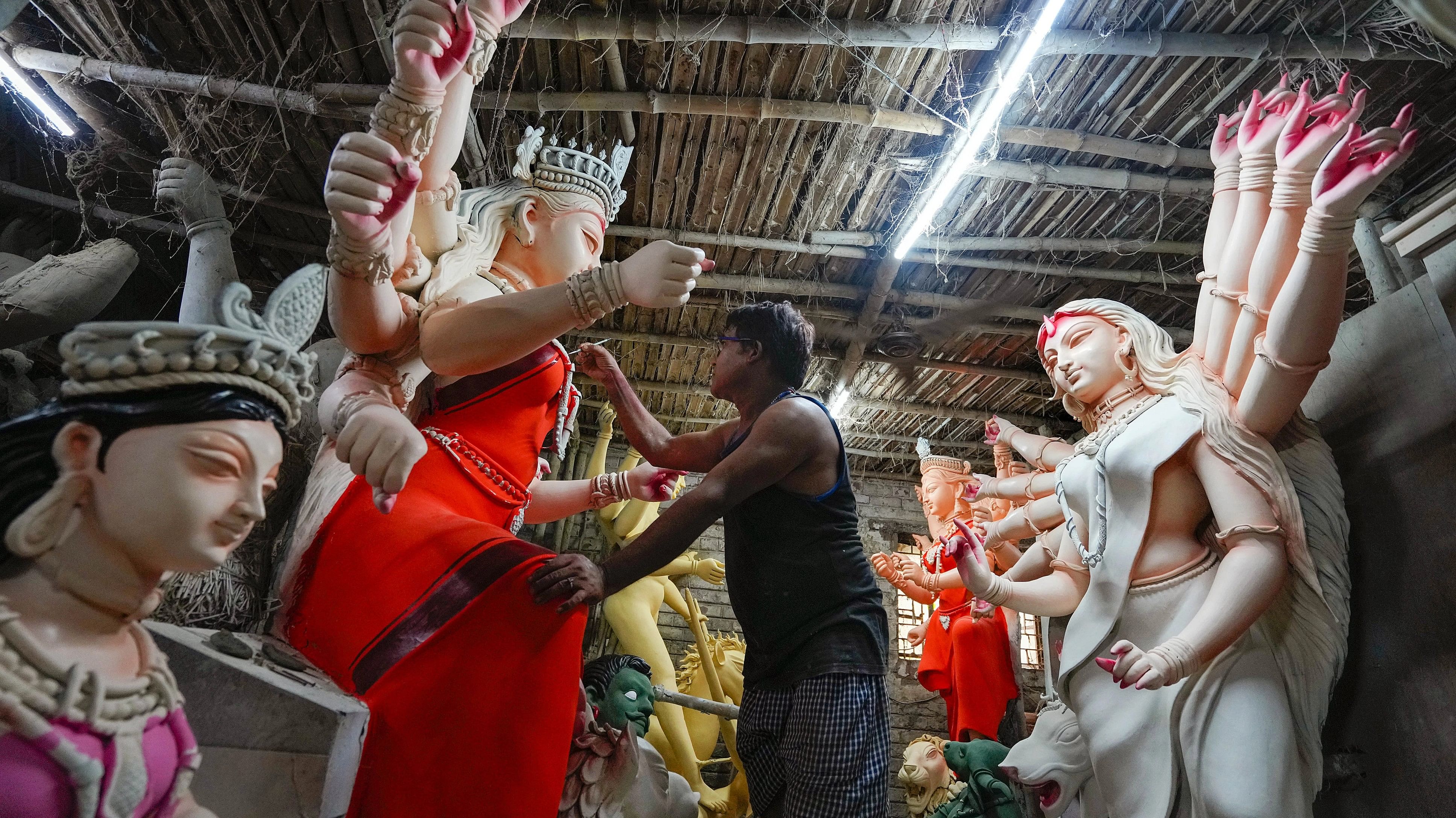 <div class="paragraphs"><p>Kolkata: An artist works on a clay idol of Goddess Durga at artisan village Kumartuli ahead of Durga Puja festival, in Kolkata, Sunday, Oct. 8, 2023. </p></div>