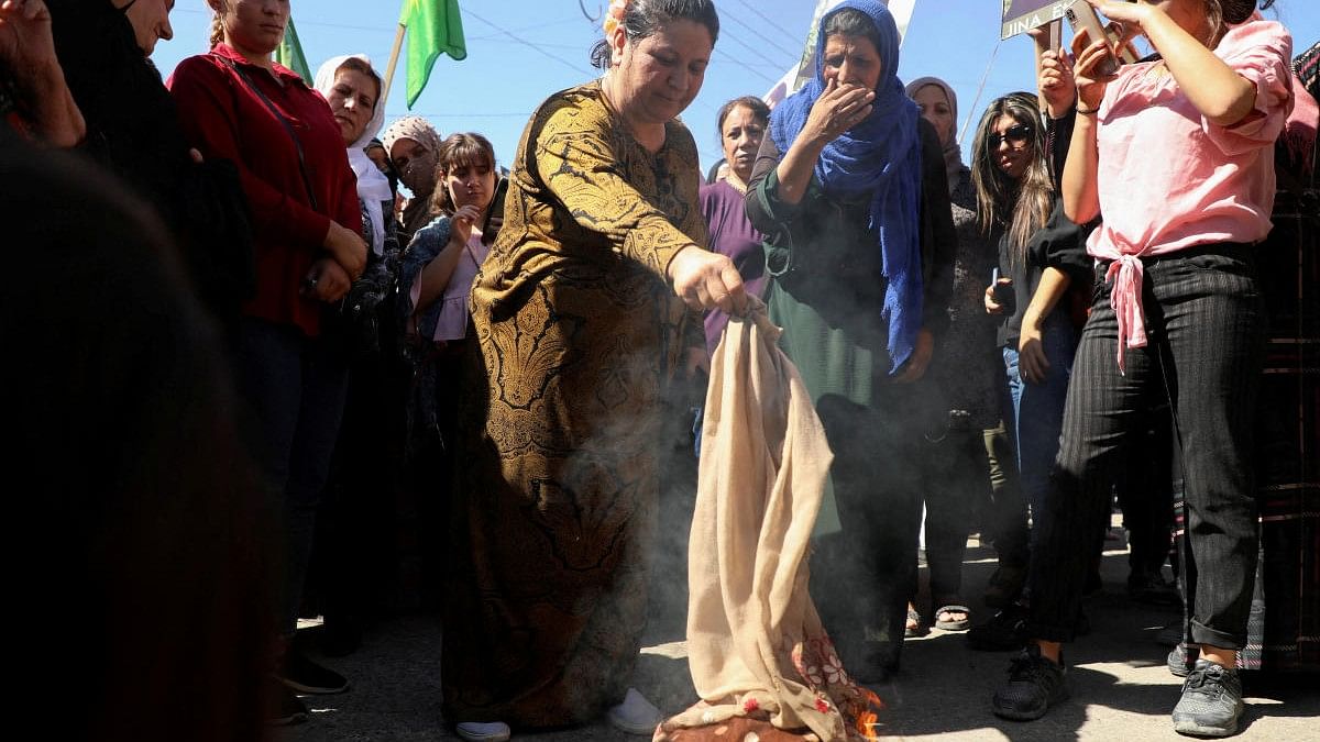 <div class="paragraphs"><p>Women burn headscarves during a protest over the death of 22-year-old Kurdish woman Mahsa Amini in Iran.</p></div>