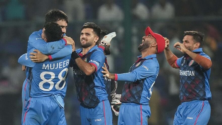 <div class="paragraphs"><p>Afghanistan players celebrate after winning the ICC Men's Cricket World Cup 2023 Group stage match against England, at Arun Jaitley Stadium in New Delhi.</p></div>