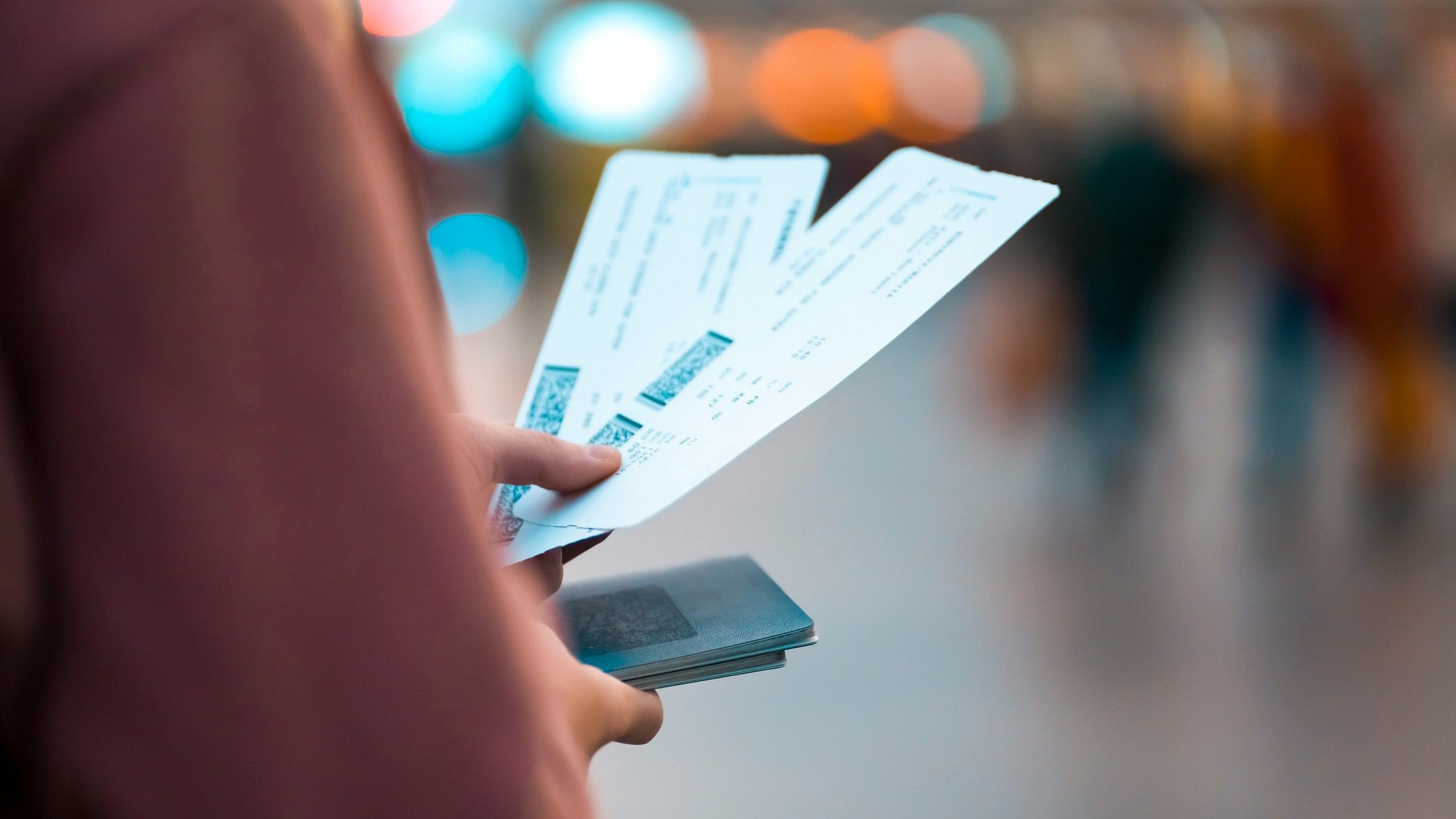 <div class="paragraphs"><p>Representative image showing a flyer holding two boarding passes.</p></div>