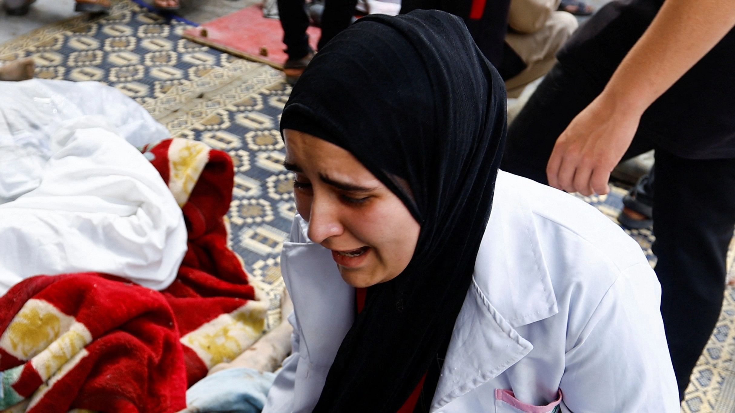 <div class="paragraphs"><p>A woman reacts at the site where Palestinians were killed in alleged Israeli strikes, at a hospital in the southern Gaza Strip, October 17, 2023.</p></div>