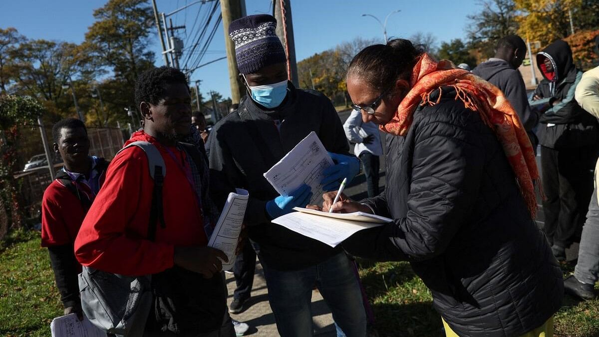 <div class="paragraphs"><p>Asylum seekers from Senegal wait in line to fill out paperwork for medical benefits across from a shelter built to house newly arrived migrants, on the campus of the Creedmoor Psychiatric Facility in Queens borough of New York City, US, October 23, 2023.</p></div>