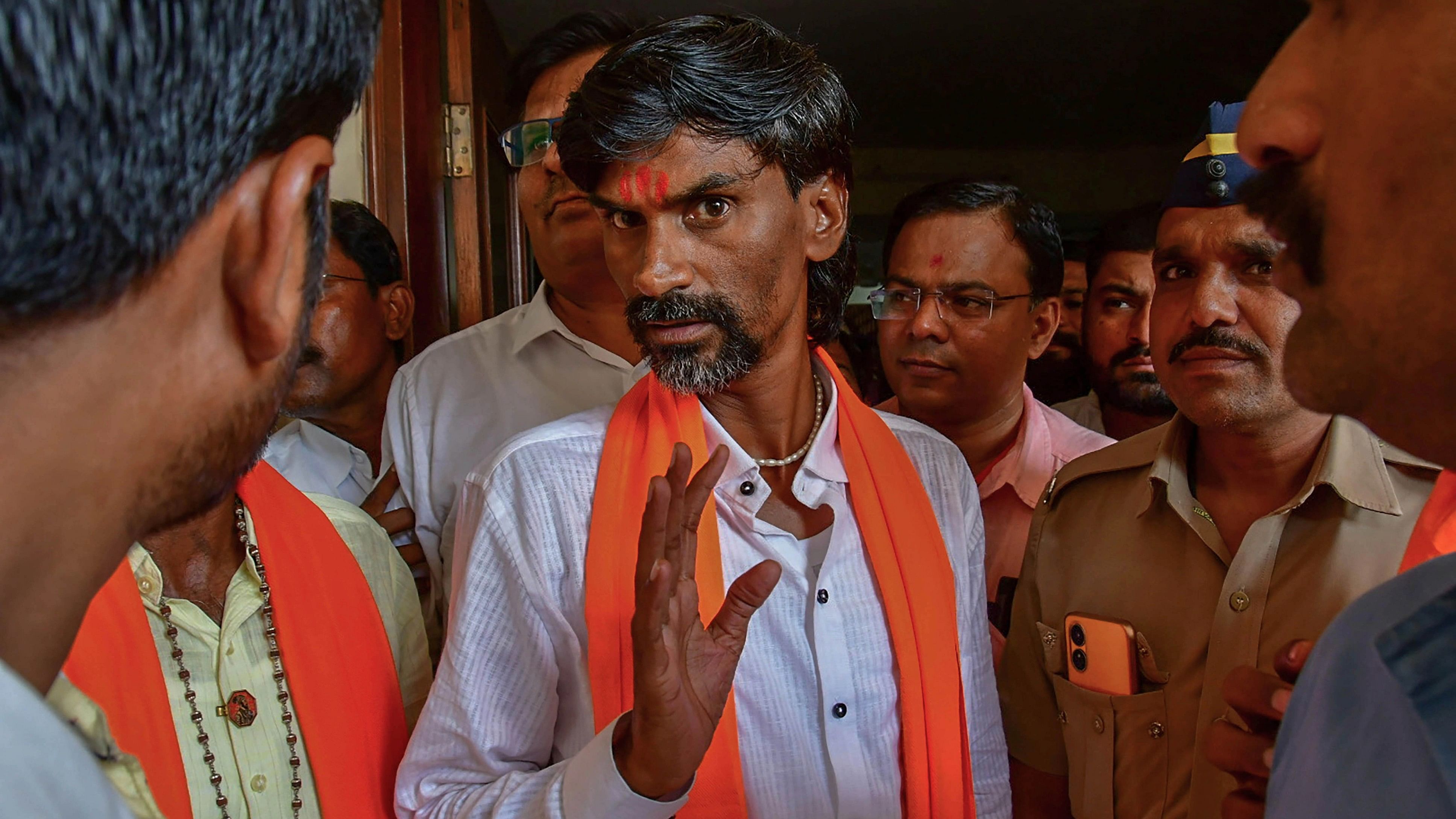 <div class="paragraphs"><p>Activist Manoj Jarange Patil with supporters at an auditorium for a meeting over Maratha reservation.</p></div>