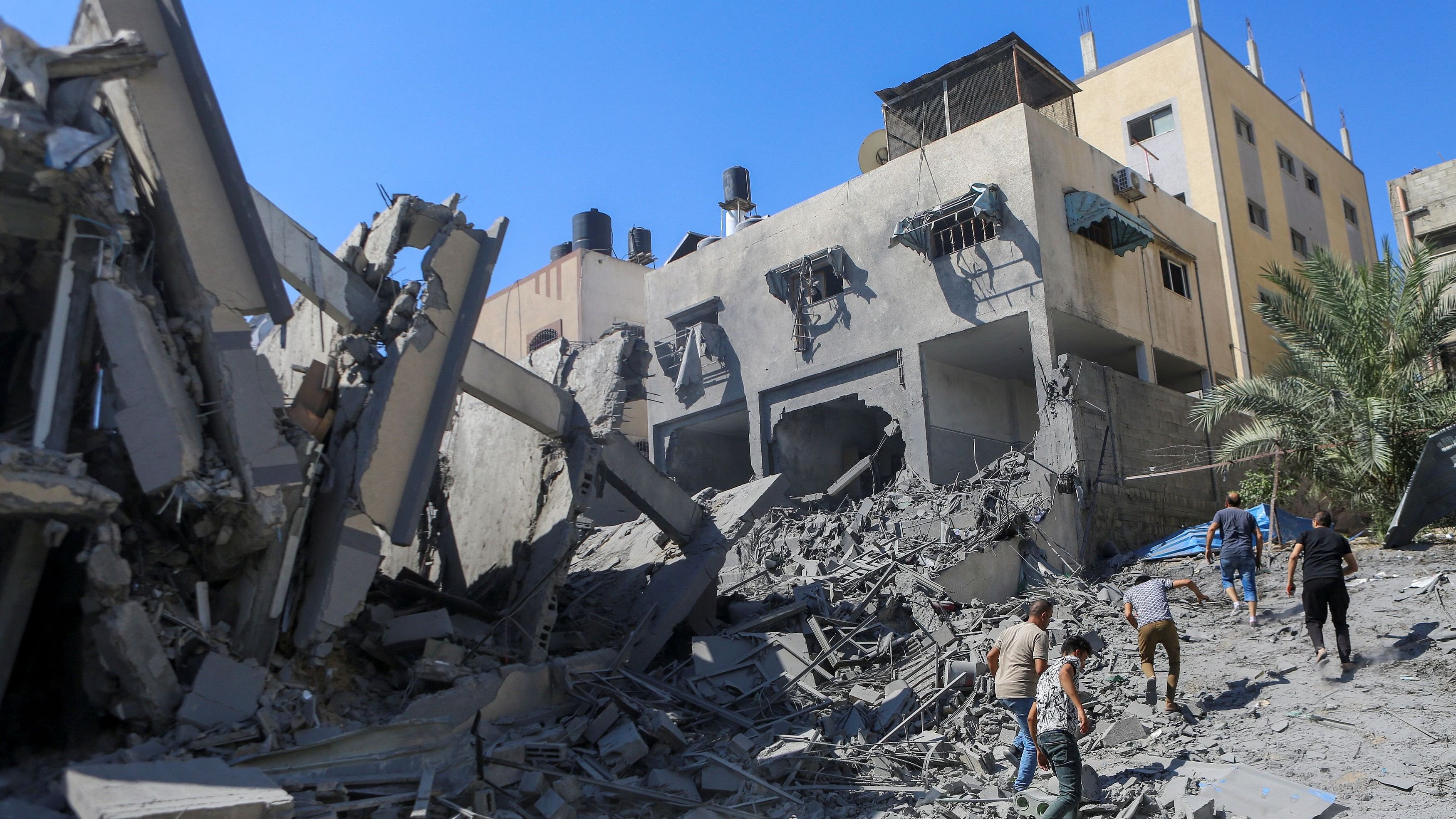 <div class="paragraphs"><p>Palestinians run past the rubble following Israeli strikes in Gaza City.</p></div>