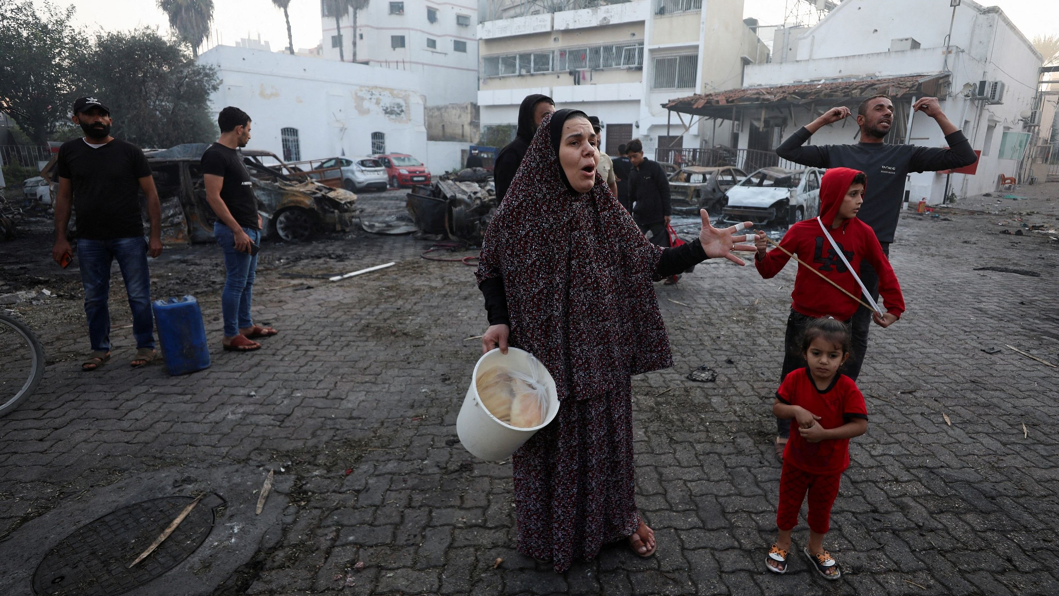 <div class="paragraphs"><p>People react at the area of Al-Ahli hospital, where hundreds of Palestinians were killed in a blast that Israeli and Palestinian officials blamed on each other, in Gaza City, October 18, 2023.</p></div>