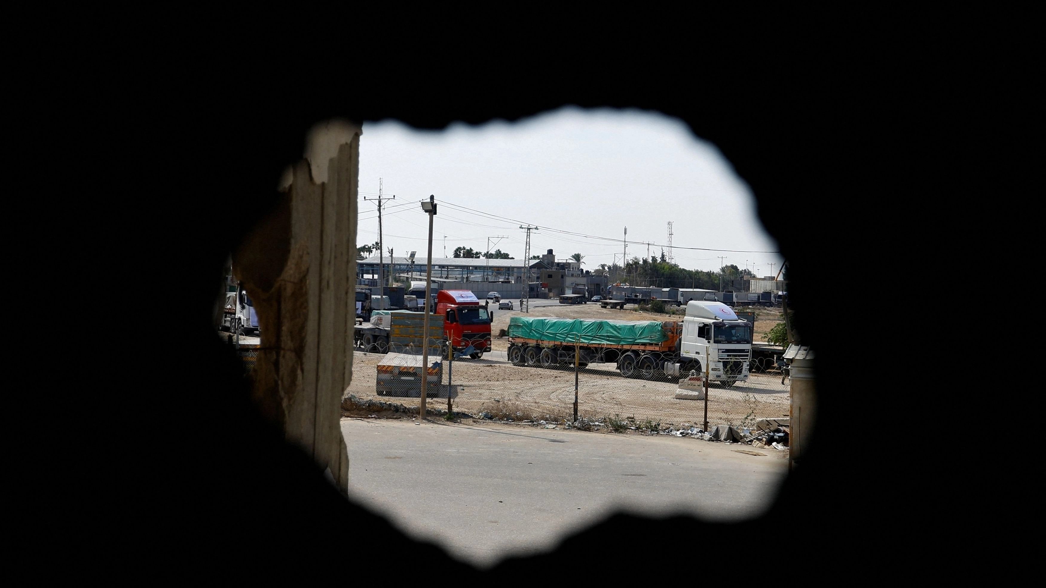 <div class="paragraphs"><p>Trucks carrying aid wait to exit, on the Palestinian side of the border with Egypt, as the conflict between Israel and Palestinian Islamist group Hamas continues, in Rafah in the southern Gaza Strip.</p></div>