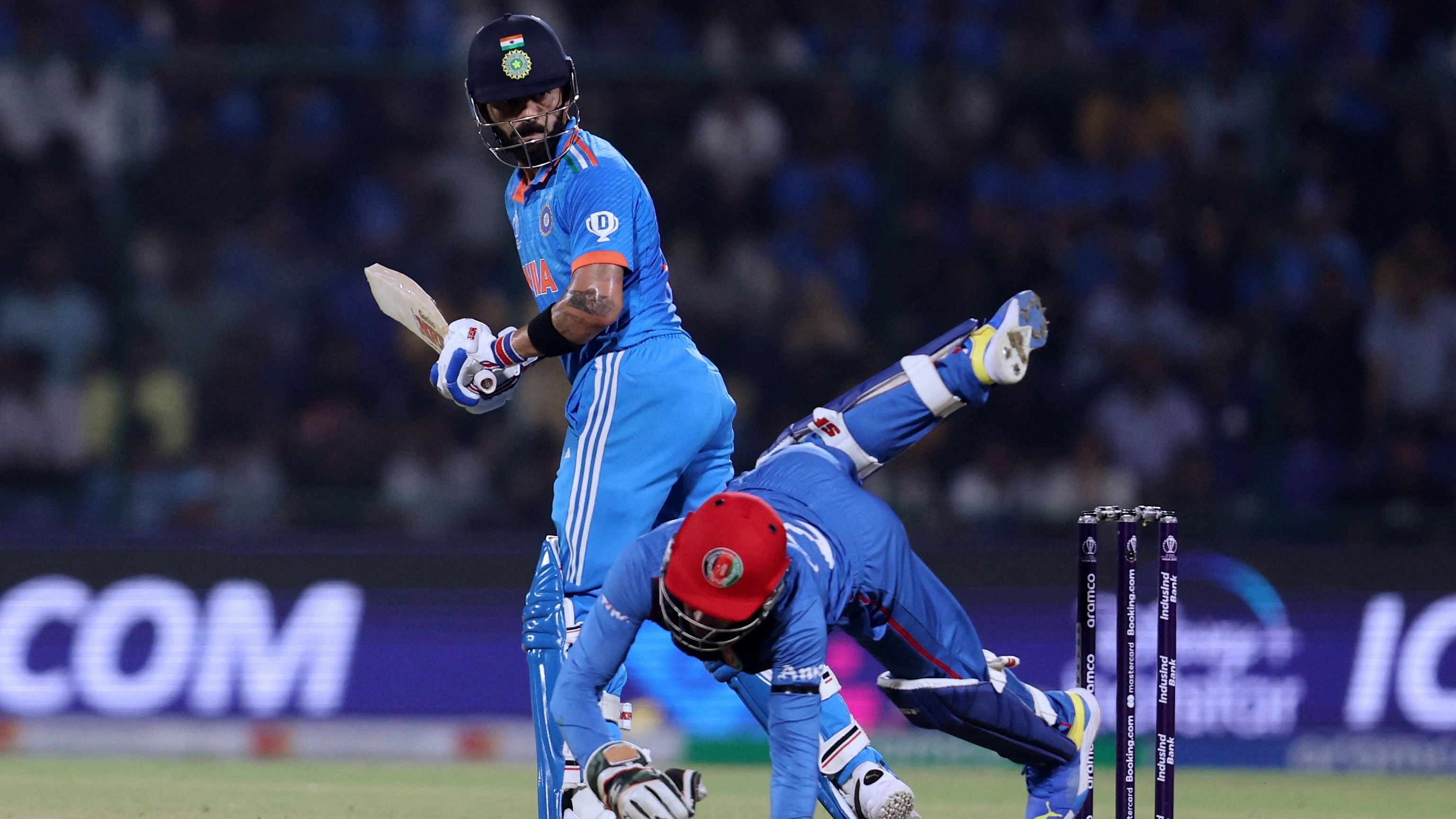 <div class="paragraphs"><p>Afghanistan's Rahmanullah Gurbaz in action as Virat Kohli looks on.</p></div>