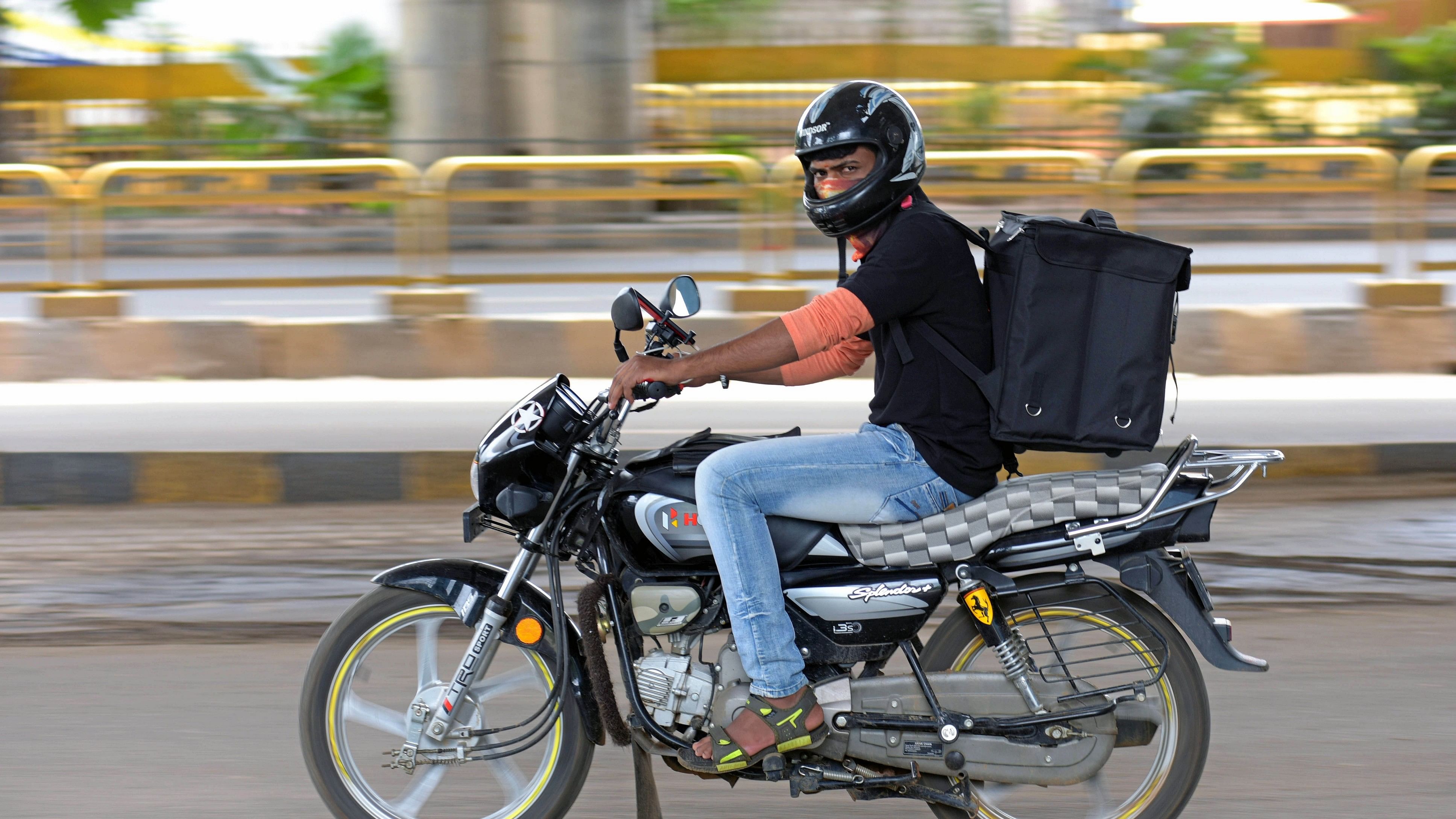 <div class="paragraphs"><p>A delivery executive zooms across the road to reach his destination in Bengaluru.&nbsp;</p></div>