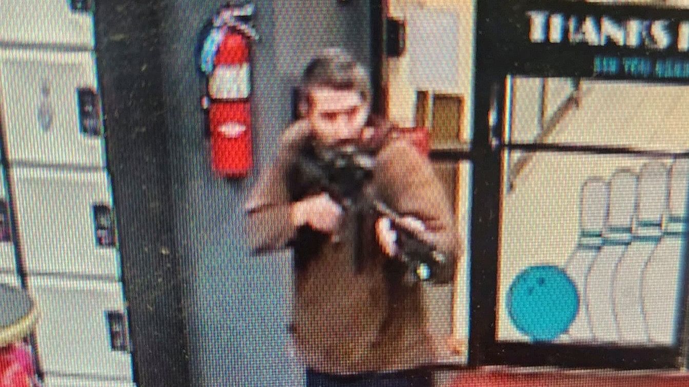 <div class="paragraphs"><p>A man identified as a suspect by police points what appears to be a semiautomatic rifle, in Lewiston, Maine, US, October 25, 2023.</p></div>