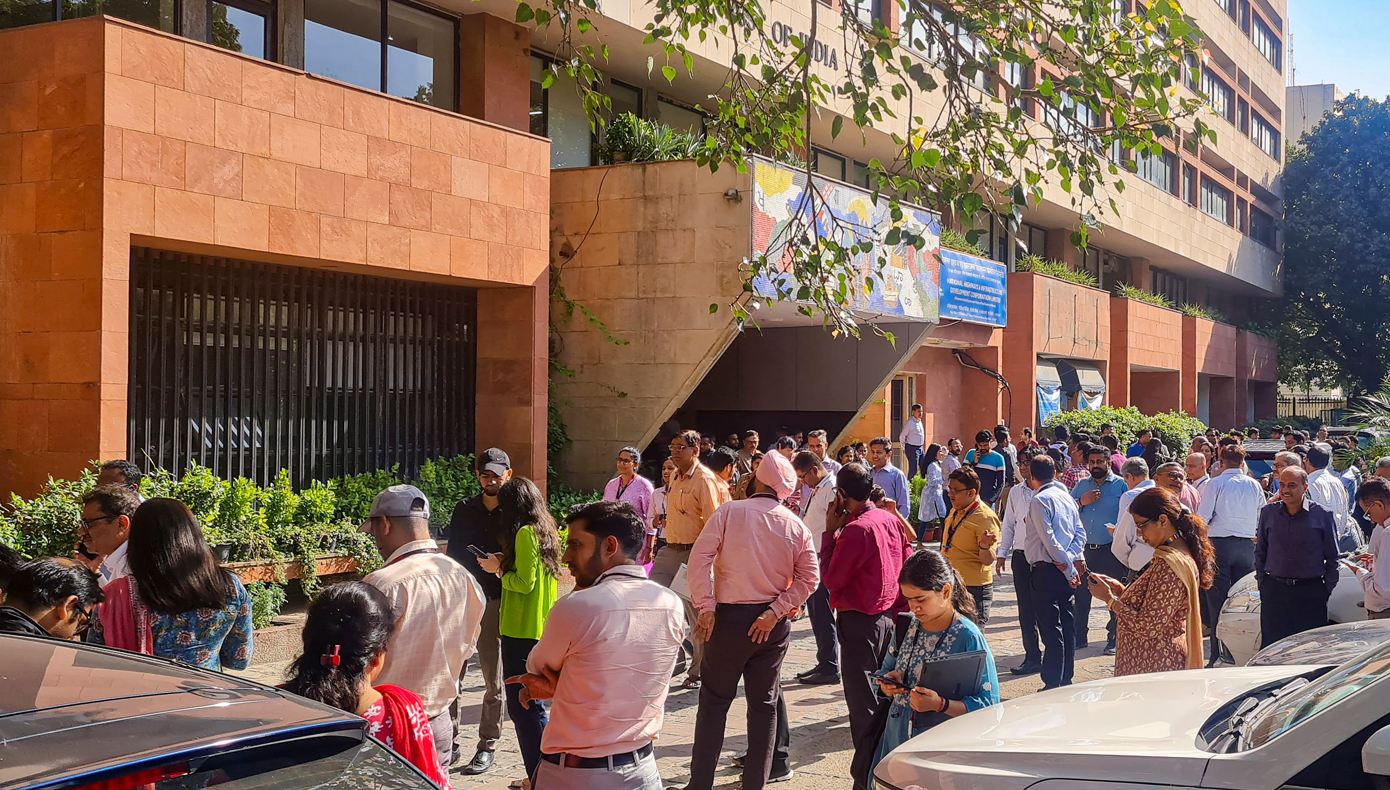 <div class="paragraphs"><p>People gather outside their offices after tremors were felt due to an earthquake, in New Delhi, Tuesday, Oct. 3, 2023.</p></div>
