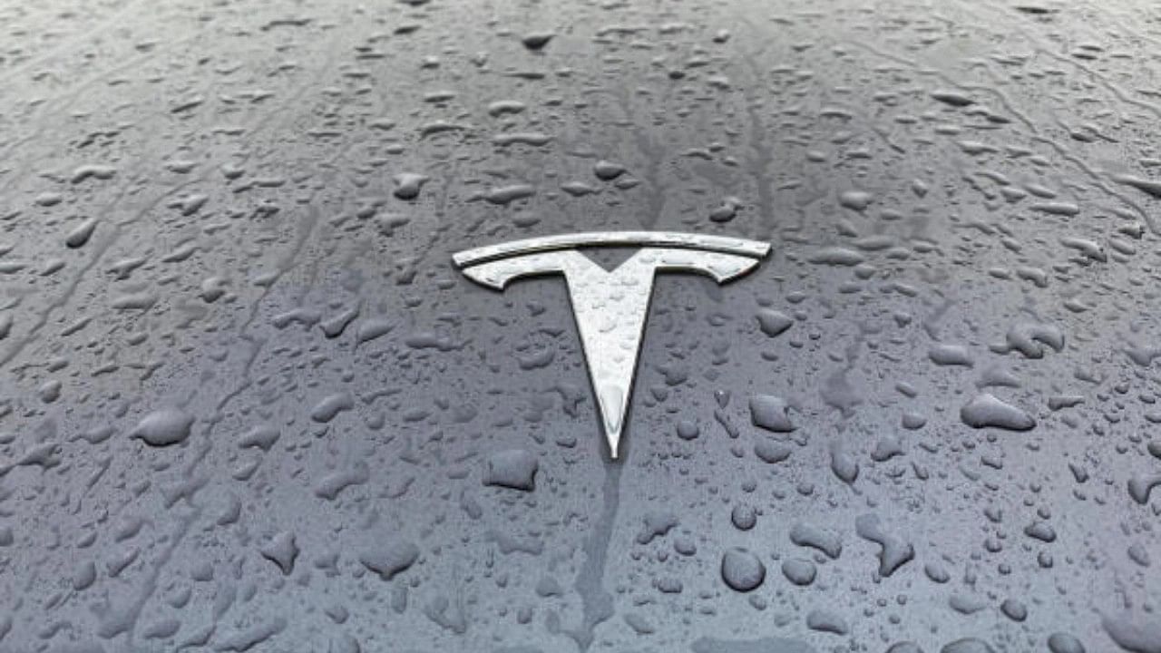 <div class="paragraphs"><p>A view shows the Tesla logo on the hood of a car. </p></div>