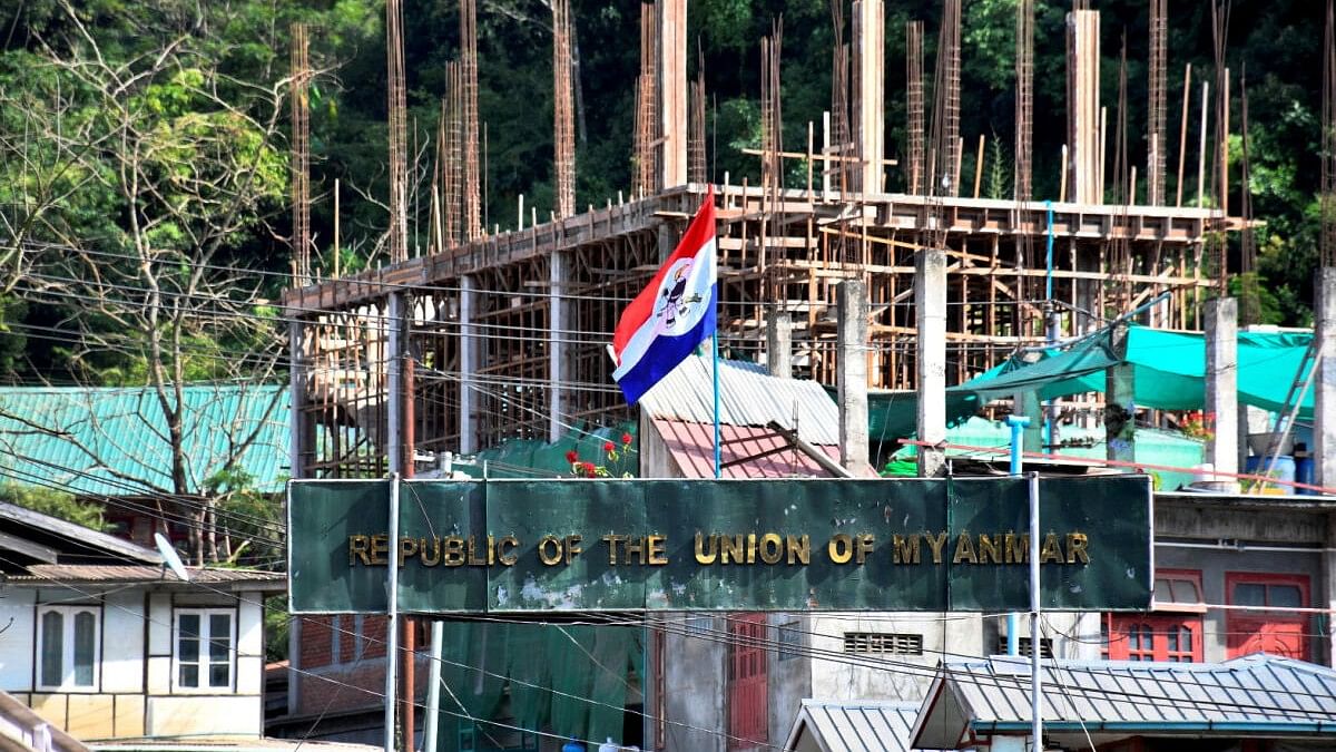 <div class="paragraphs"><p>A flag of one of the Myanmar rebel forces is installed next to an under-construction structure in Myanmar's Khawmawi village on the India-Myanmar border as seen from Zokhawthar village in Champhai district of India's northeastern state of Mizoram, India.</p></div>