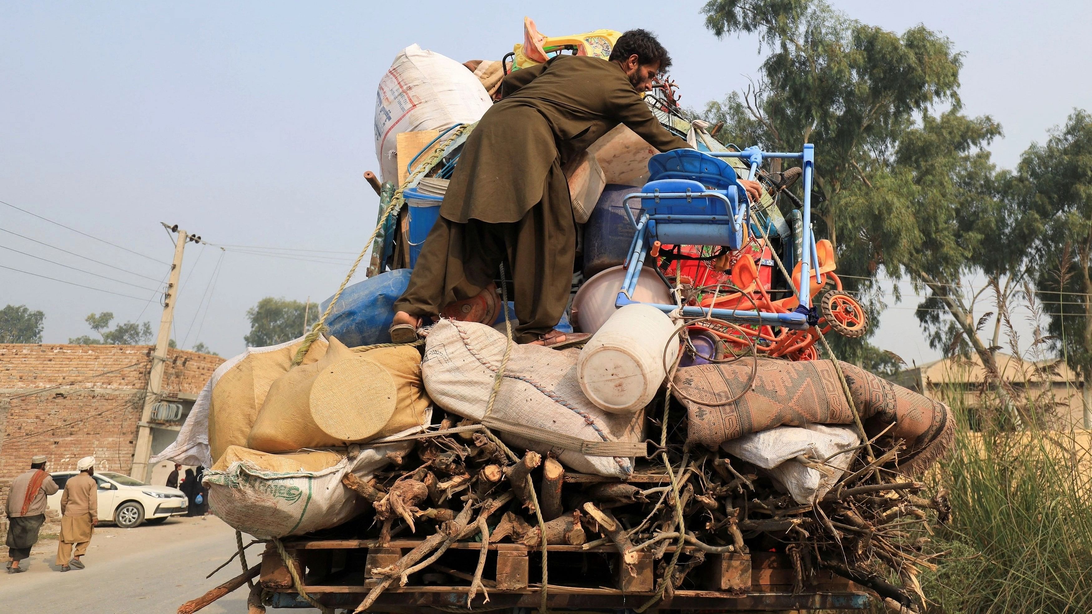 <div class="paragraphs"><p>An Afghan refugee man loads a truck with his belongings, as he along with others is returning home, after Pakistan gives the last warning to undocumented immigrants to leave, outside the United Nations High Commissioner for Refugees  repatriation centres in Azakhel town in Nowshera, Pakistan October 30, 2023.</p></div>