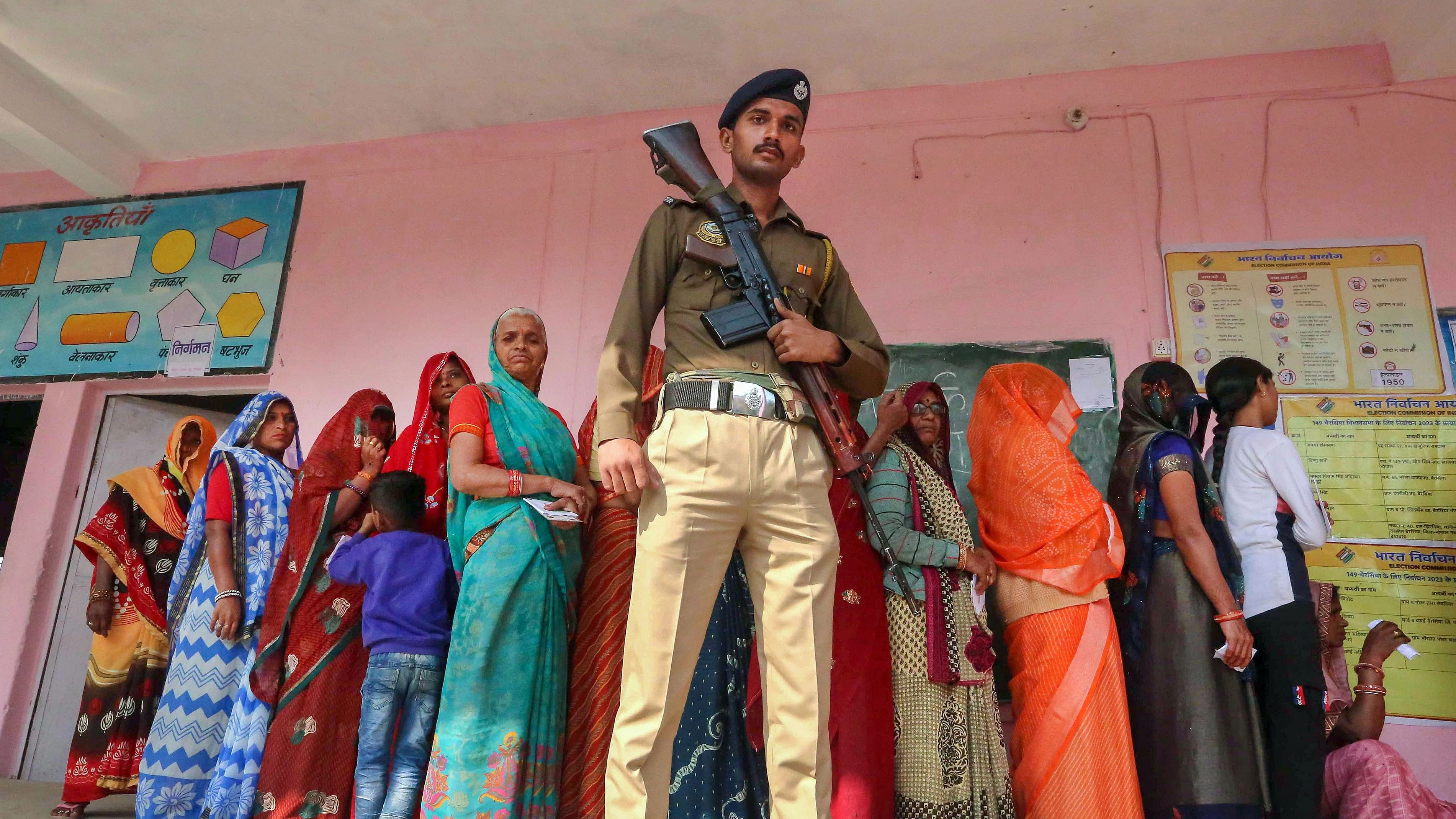 <div class="paragraphs"><p>Bhopal: A police officer stands guard as women voters wait in queue to cast their votes at a polling booth during Madhya Pradesh Assembly elections, in the outskirts of Bhopal, Friday, Nov. 17, 2023. </p></div>