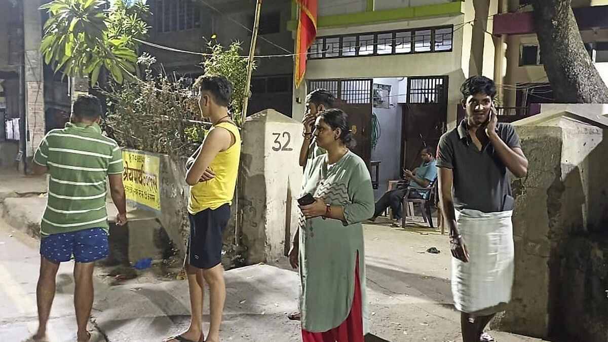 <div class="paragraphs"><p>People gather outside their offices after tremors were felt due to an earthquake, in Patna, Friday night, Nov 3, 2023.</p></div>