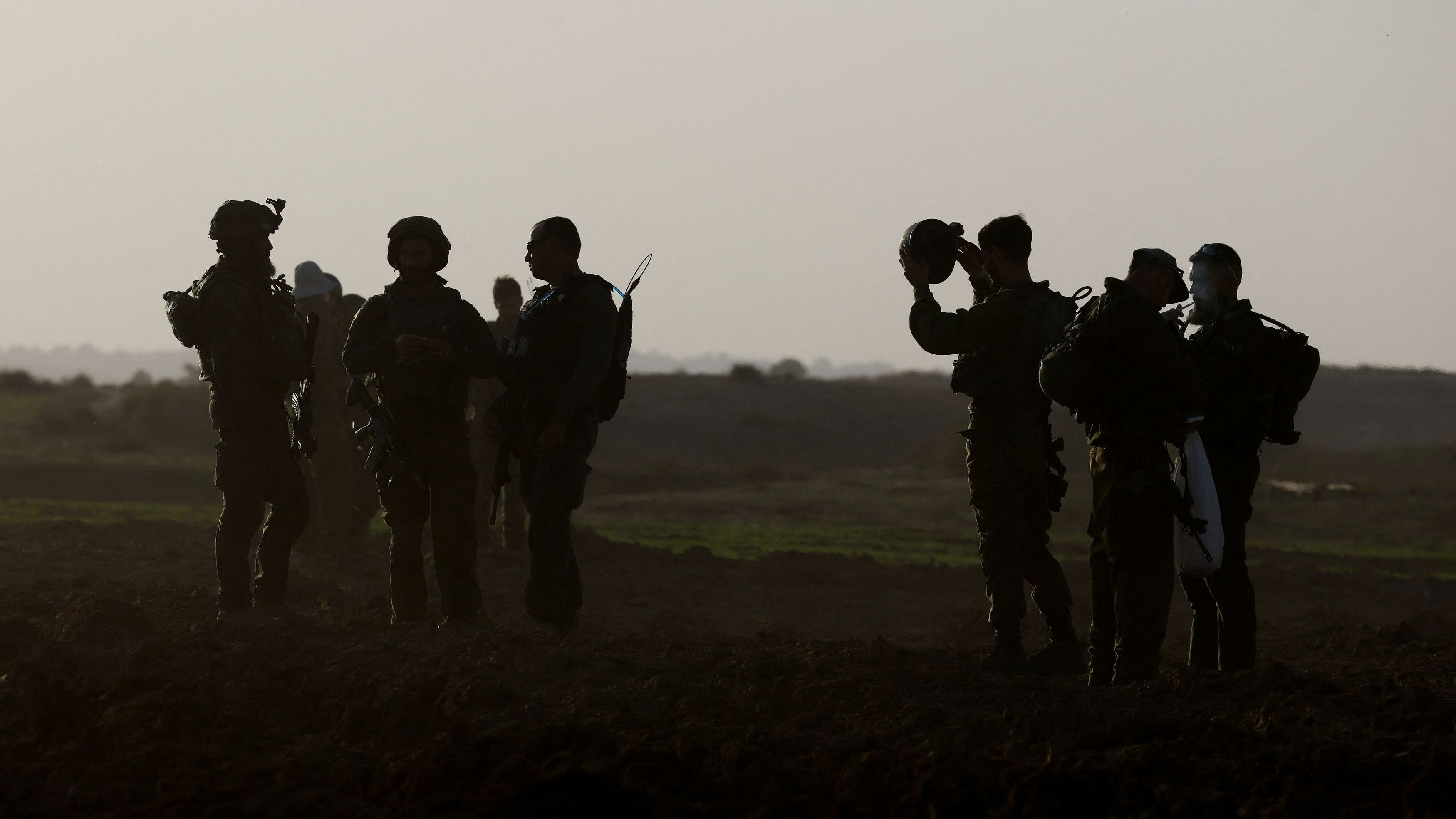 <div class="paragraphs"><p>Israeli soldiers stand, amid the ongoing conflict between Israel and the Palestinian group Hamas, near Israel's border with Gaza in southern Israel, November 23, 2023.</p></div>