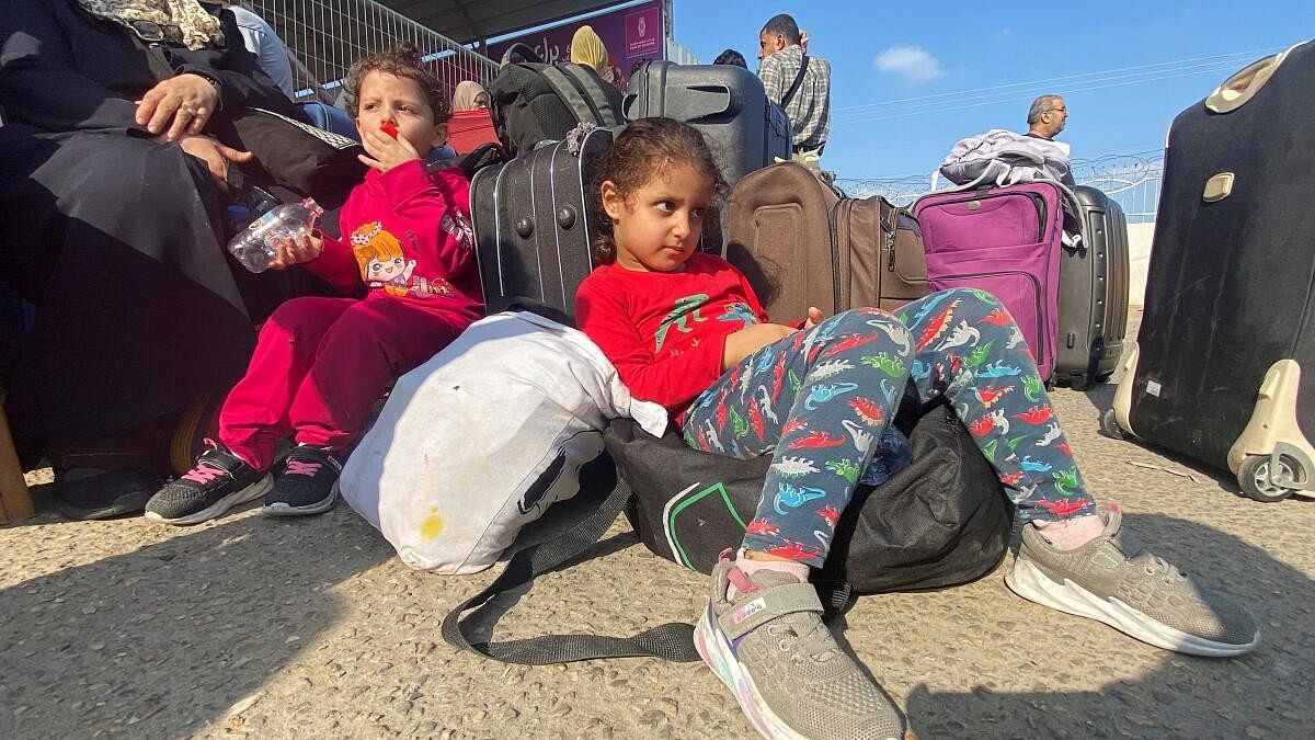 <div class="paragraphs"><p>Palestinian children with dual citizenship wait outside the Rafah border crossing with Egypt, in the hope of getting permission to leave Gaza, amid the ongoing conflict between Israel and Palestinian Islamist group Hamas, in Rafah in the southern Gaza Strip, November 1, 2023.</p></div>