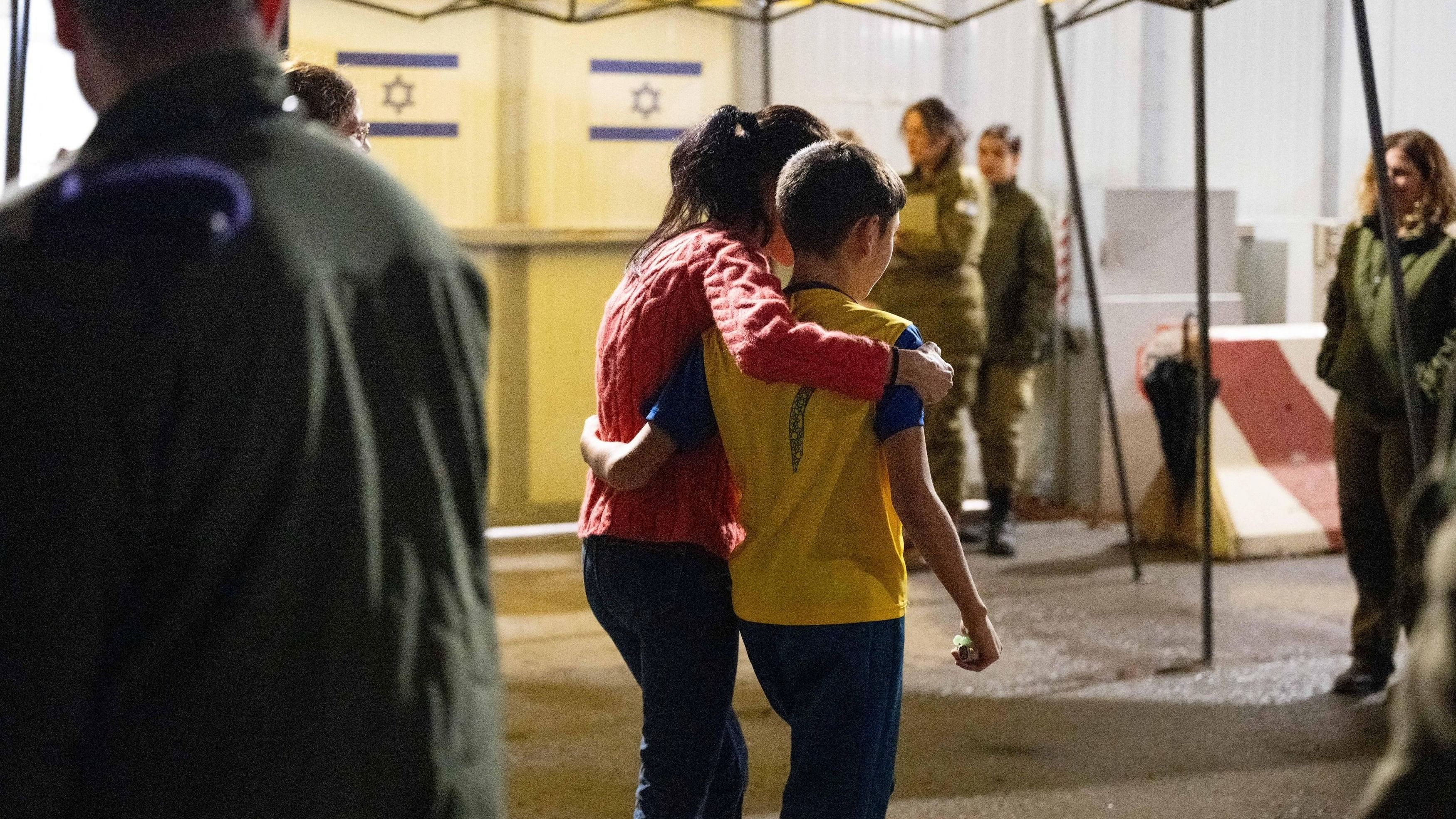 <div class="paragraphs"><p>Eitan Yahalomi, 12, walks with his mother at the Kerem Shalom border crossing, after being released from Gaza where he was kept hostage following the October 7 attack by Palestinian militant group Hamas, in Israel, in this handout image obtained by Reuters on November 28, 2023. </p></div>