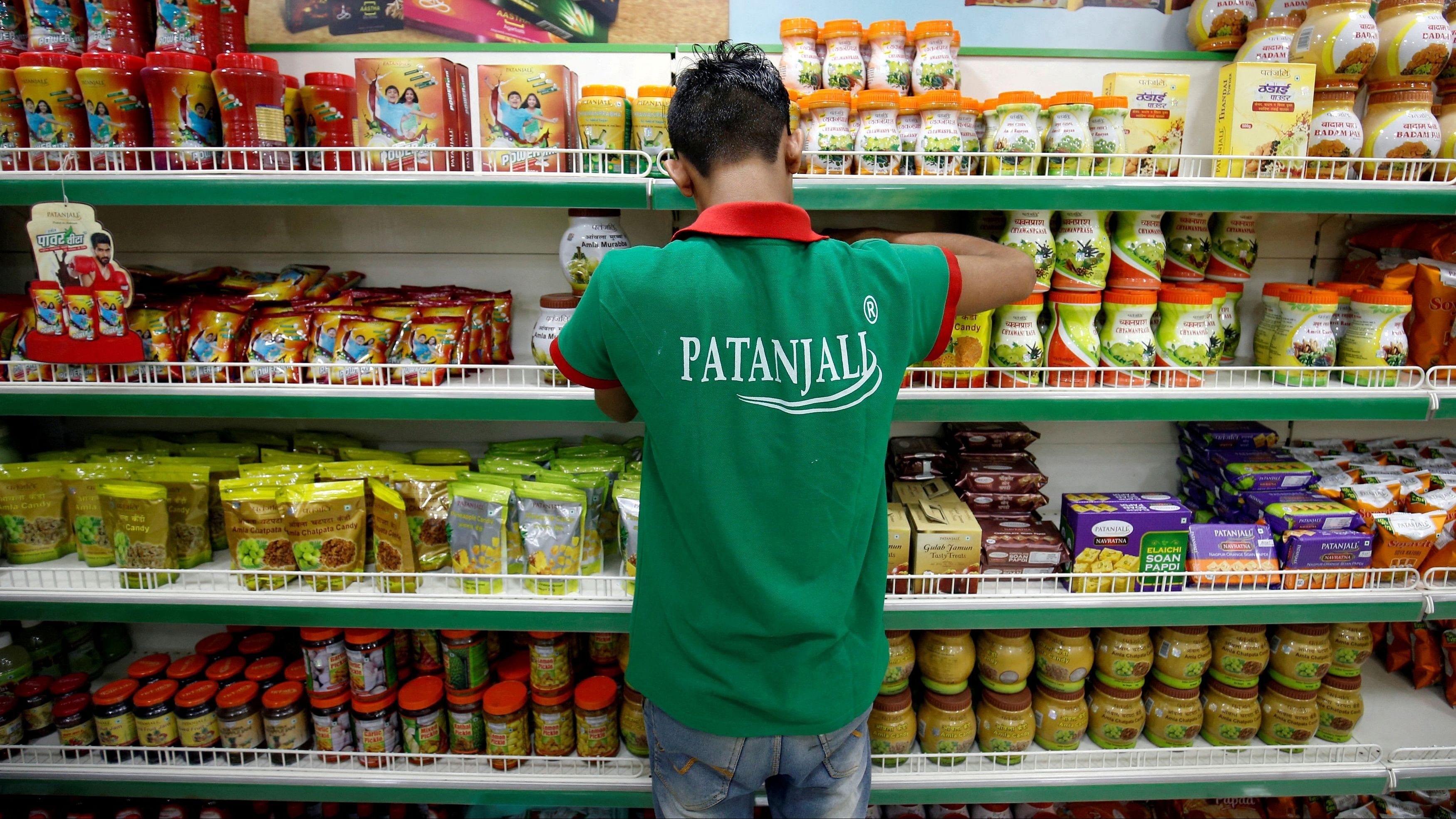 <div class="paragraphs"><p>A worker arranges consumable goods inside a Patanjali store in Ahmedabad, India,</p></div>