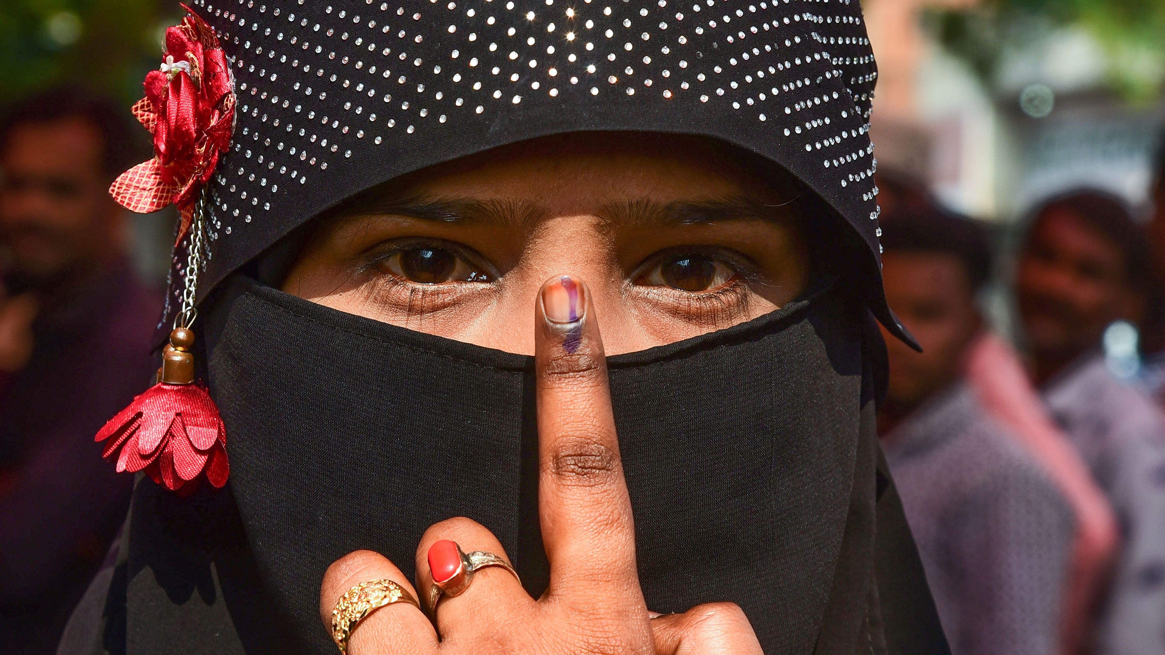 <div class="paragraphs"><p>A voter shows her finger marked with indelible ink after casting her vote.&nbsp;</p></div>