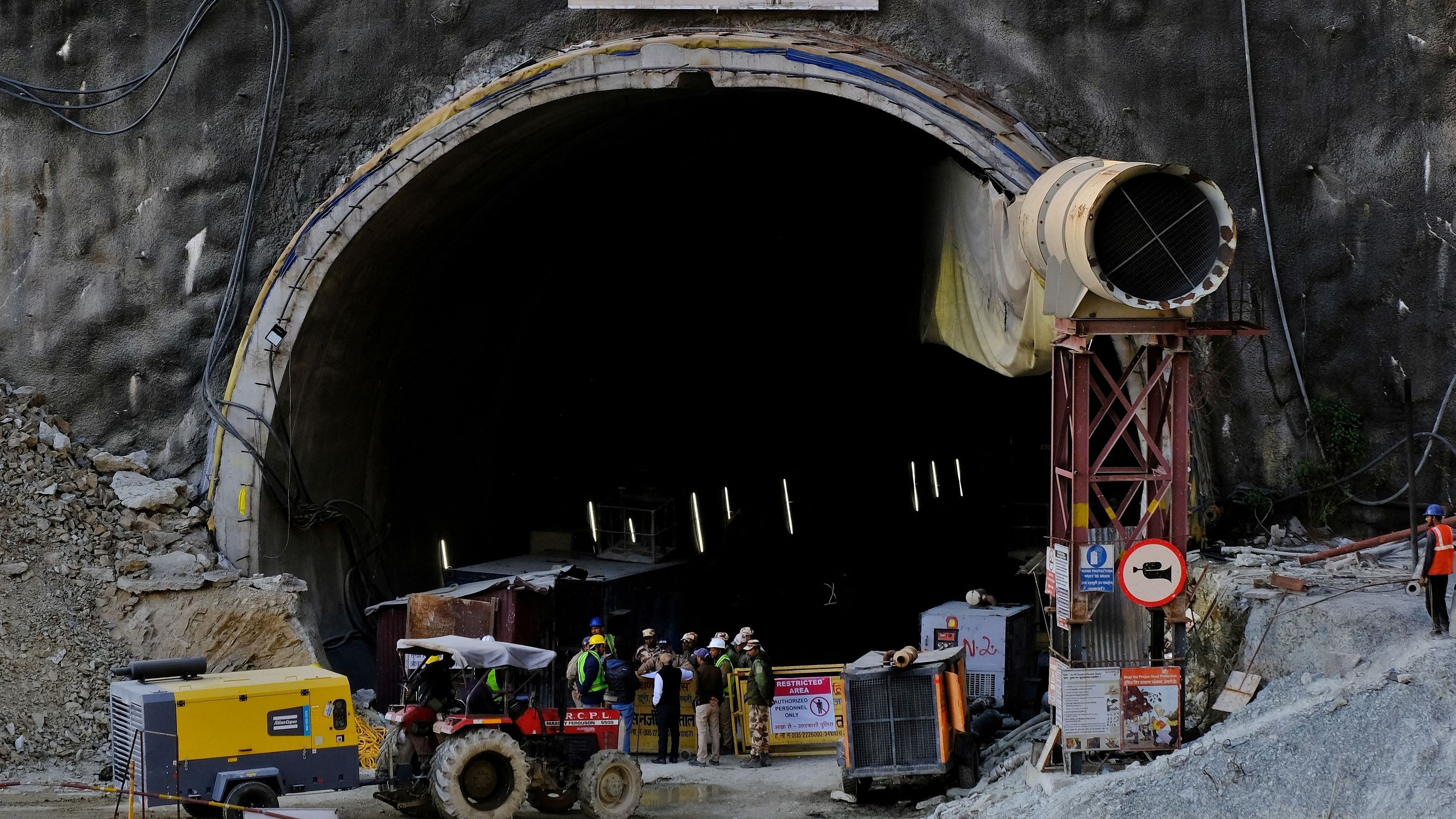 <div class="paragraphs"><p>Members of rescue teams stand at the entrance of a tunnel where road workers are trapped after a portion of the tunnel collapsed in Uttarkashi in Uttarakhand.</p></div>