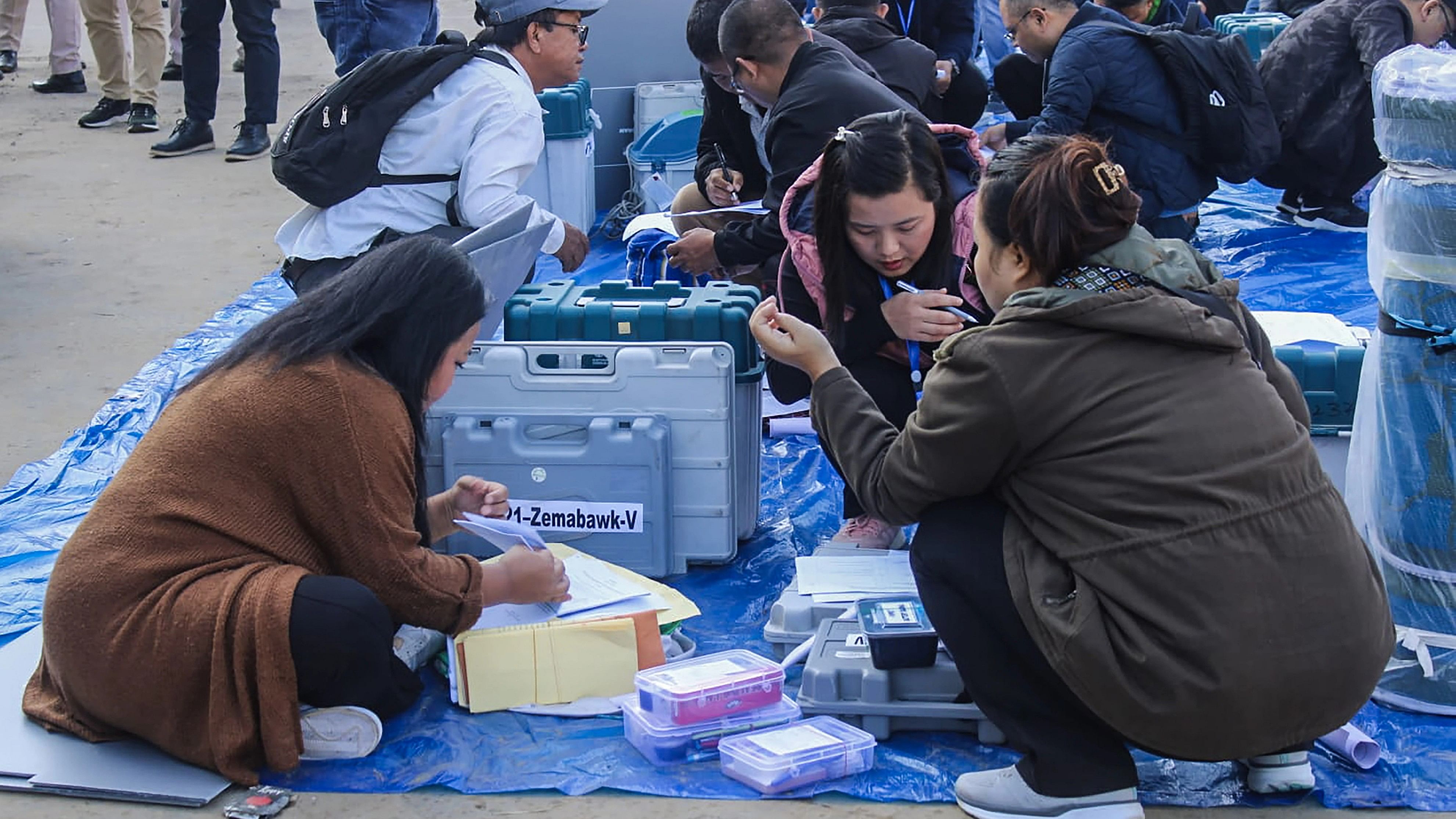 <div class="paragraphs"><p> Polling officials collect EVMs and other election material at a distribution centre ahead of voting for Mizoram Assembly elections.</p></div>