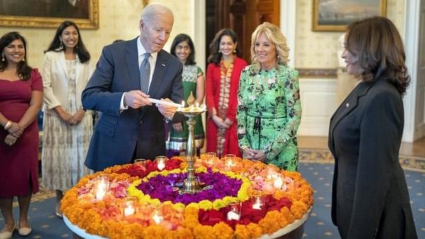 <div class="paragraphs"><p>United States President Joe Biden lights a lamp as First lady Jill Biden and Vice President Kamala Harris look on during an event to celebrate Diwali, at the White House in Washington.</p></div>