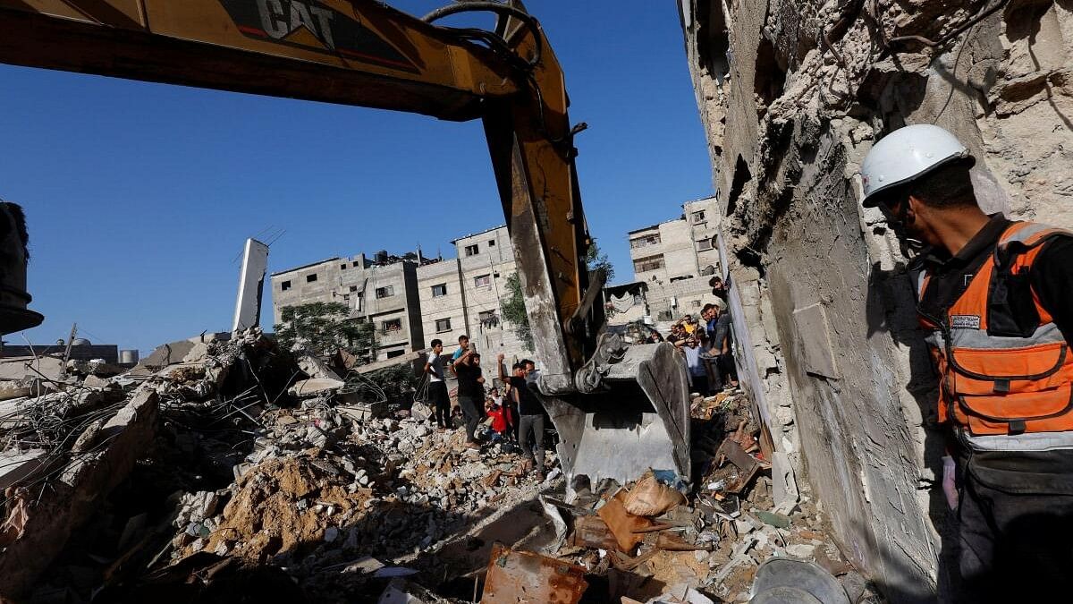 <div class="paragraphs"><p>Palestinians gather at the site of Israeli strikes on a residential building, amid the ongoing conflict between Israel and Palestinian Islamist group Hamas, in Khan Younis in the southern Gaza Strip, November 4, 2023.</p></div>