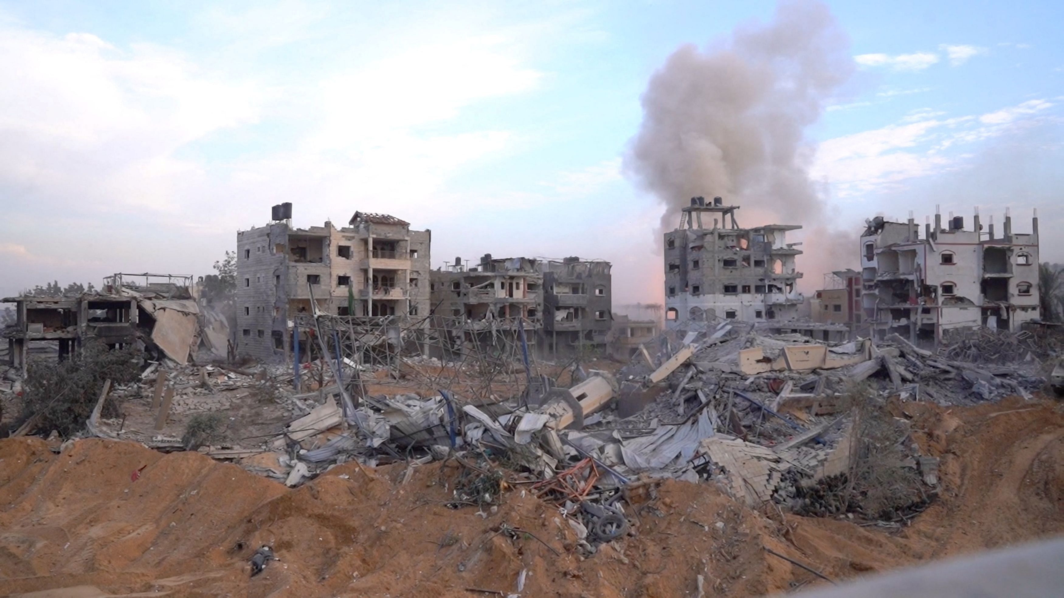 <div class="paragraphs"><p>Smoke rises&nbsp;over buildings as Israeli soldiers operate inside the Gaza Strip, amid the ongoing ground operation of the Israeli army against Palestinian Islamist group Hamas.</p></div>