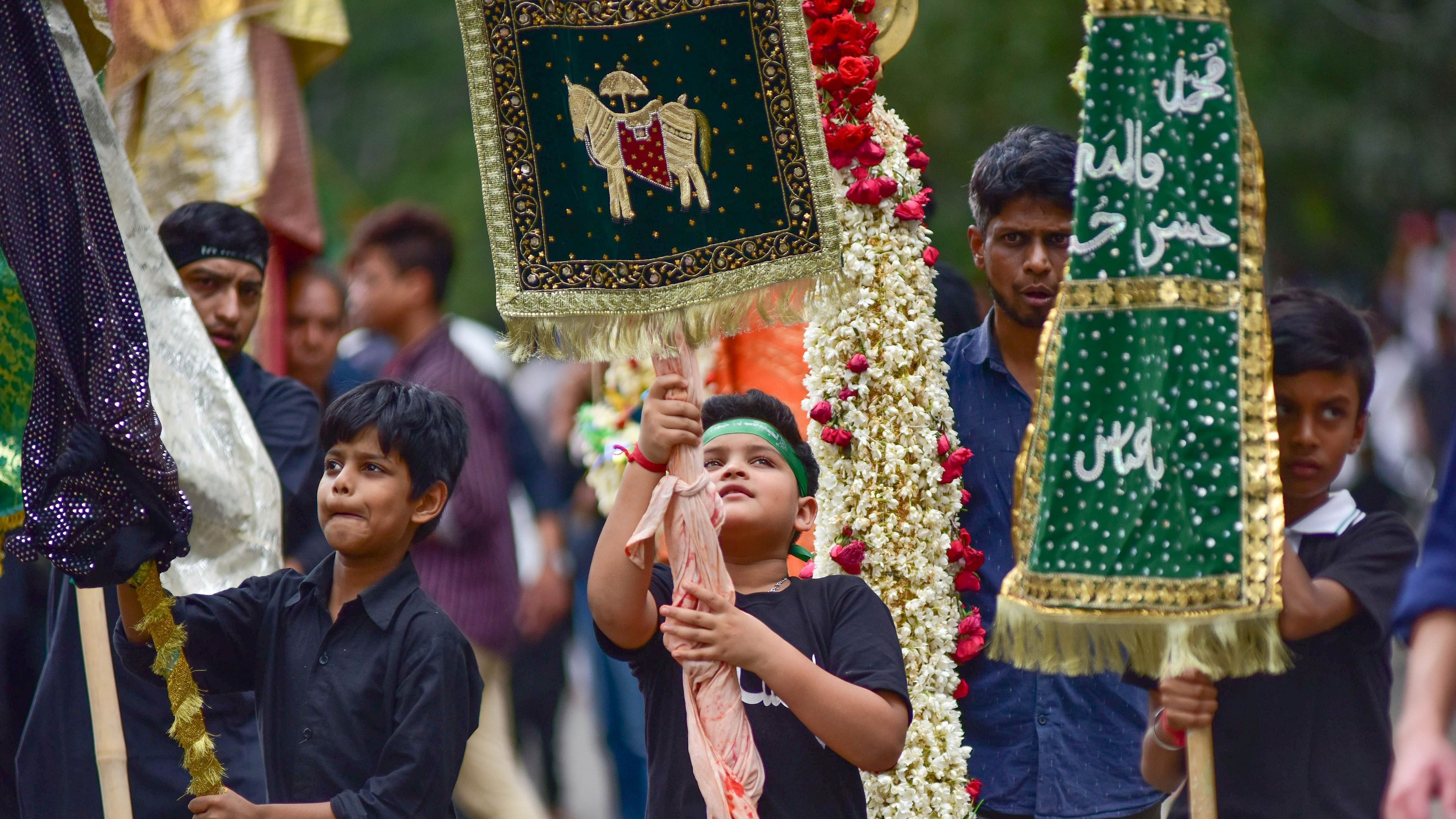 <div class="paragraphs"><p>Children carry alams and take part in the Muharram procession in Karnataka. </p></div>