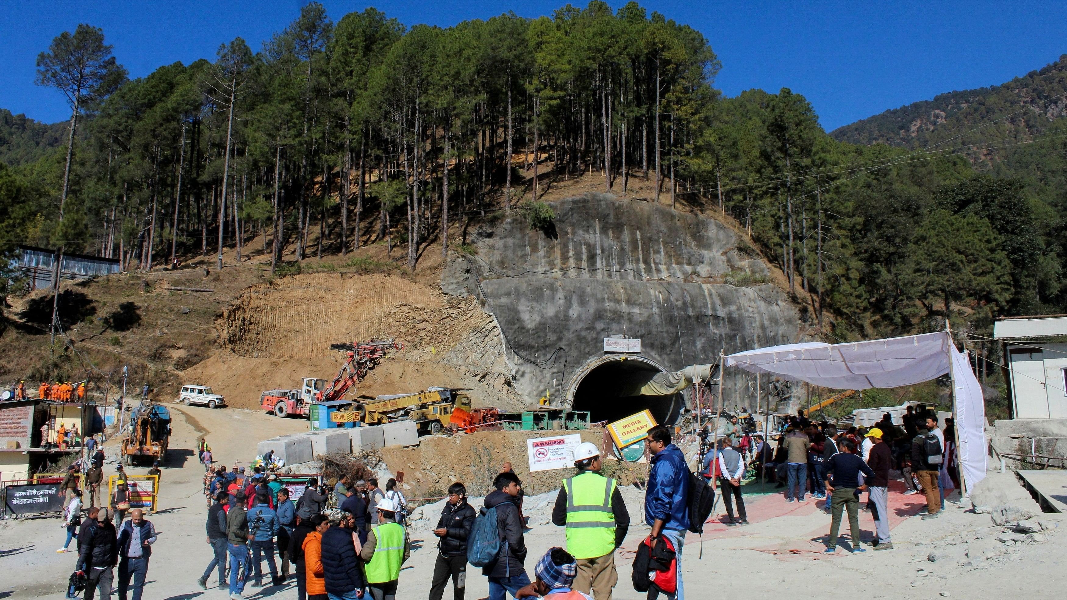 <div class="paragraphs"><p>Media personnel and onlookers gather near the entrance of a tunnel under construction where workers are trapped following a collapse, in Uttarkashi.</p></div>