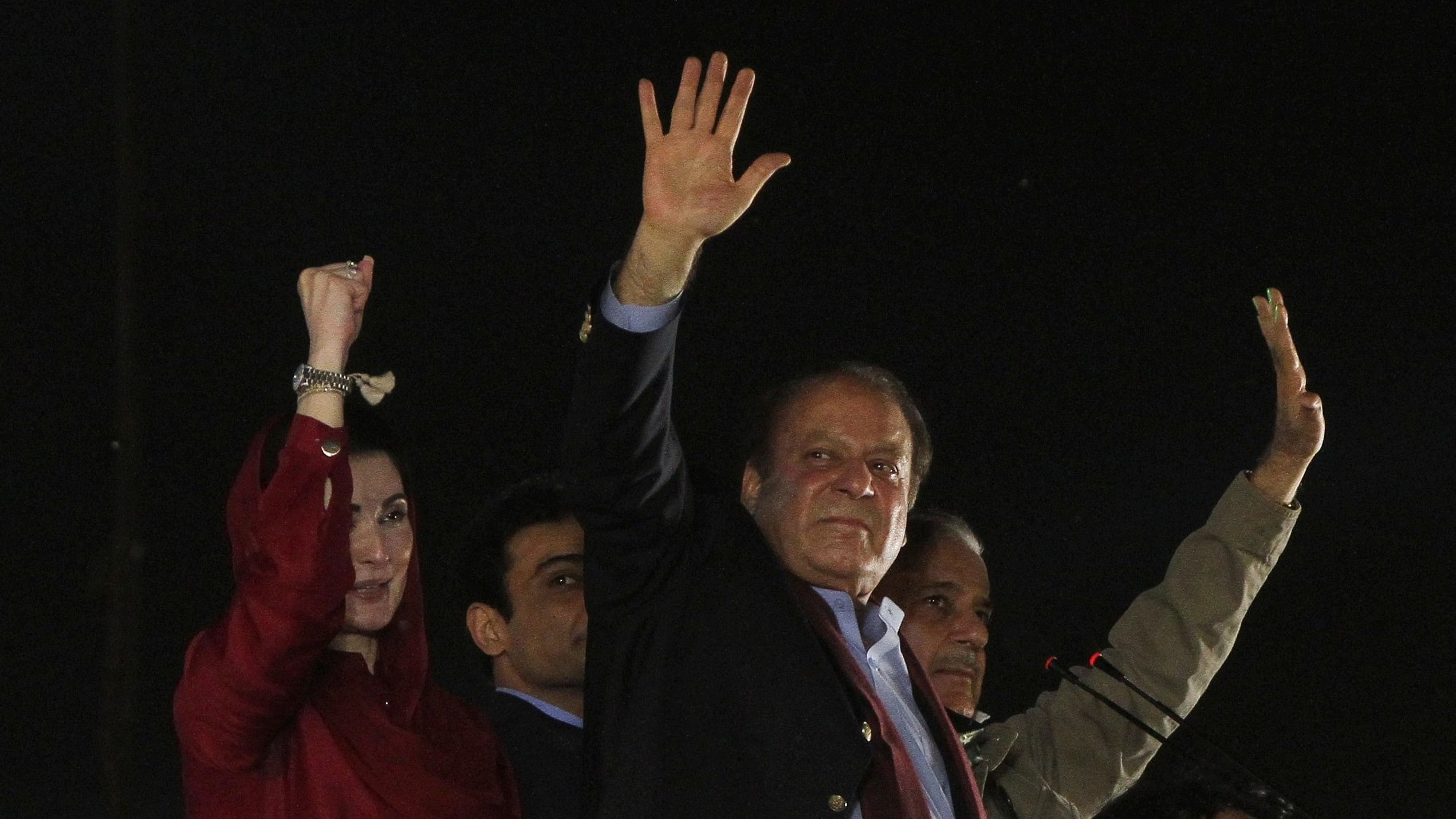 <div class="paragraphs"><p>File Photo: Pakistan's former Prime Minister Nawaz Sharif along with his brother, former Prime Minister Shehbaz Sharif, and daughter Maryam Nawaz Sharif, gestures to supporters upon his arrival from a self-imposed exile in London, ahead of the 2024 Pakistani general election, in Lahore, Pakistan, October 21, 2023. </p></div>