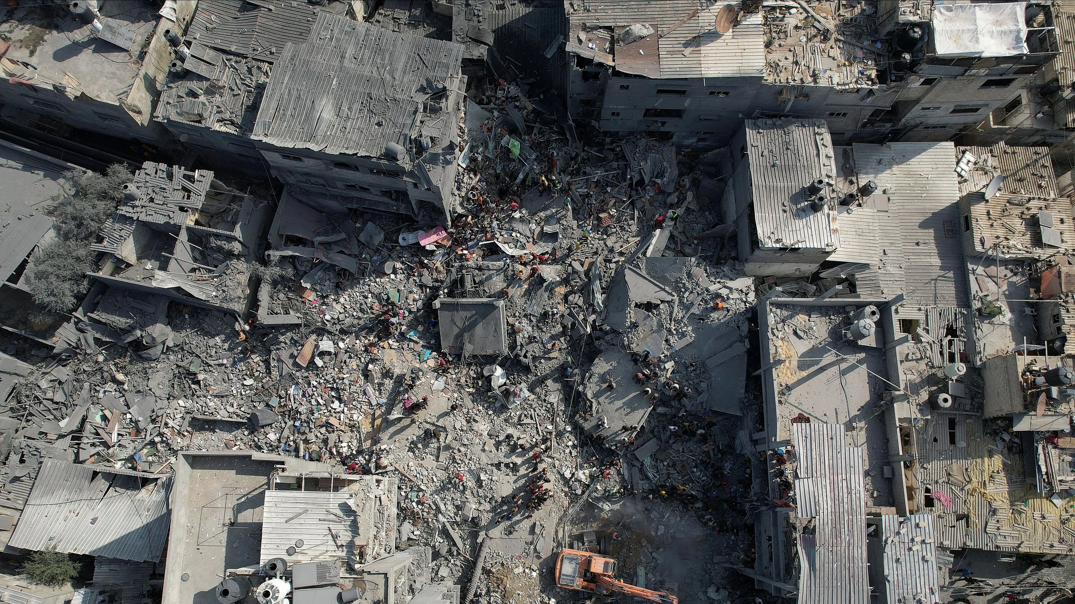 <div class="paragraphs"><p>Palestinians search for casualties, at the site of Israeli strikes on houses, amid the ongoing conflict between Israel and Palestinian Islamist group Hamas, at the Magazi Refugee Camp, in central Gaza Strip.</p></div>