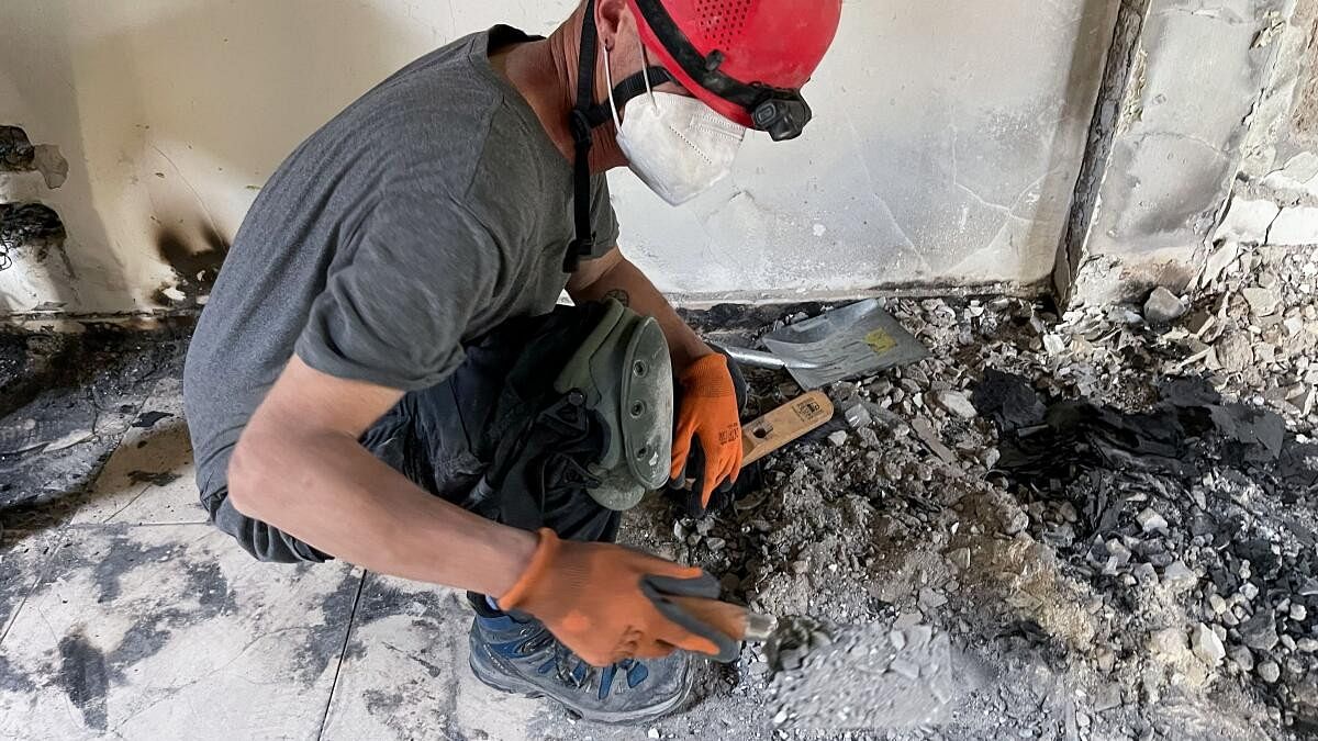 <div class="paragraphs"><p>An archeologist from the Israel Antiquities Authority (IAA) sifts through the remains of burnt-out houses to look for human remains to identify victims that have been missing since the deadly October 7 attack by Hamas gunmen from the Gaza Strip, at Kibbutz Nir Oz, in southern Israel, November 9, 2023.</p></div>