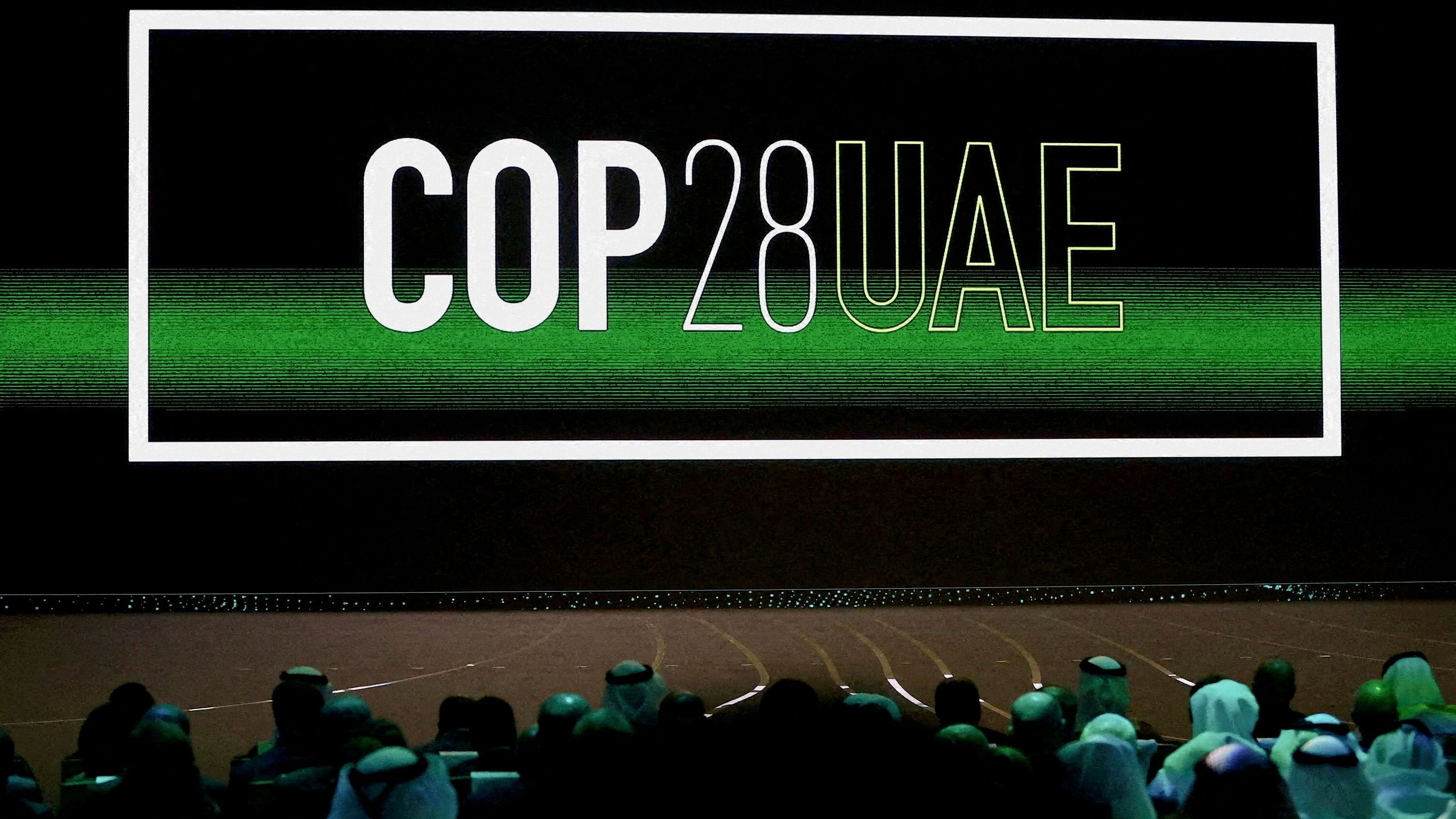 <div class="paragraphs"><p>''Cop28 UAE' logo is displayed on the screen.</p></div>