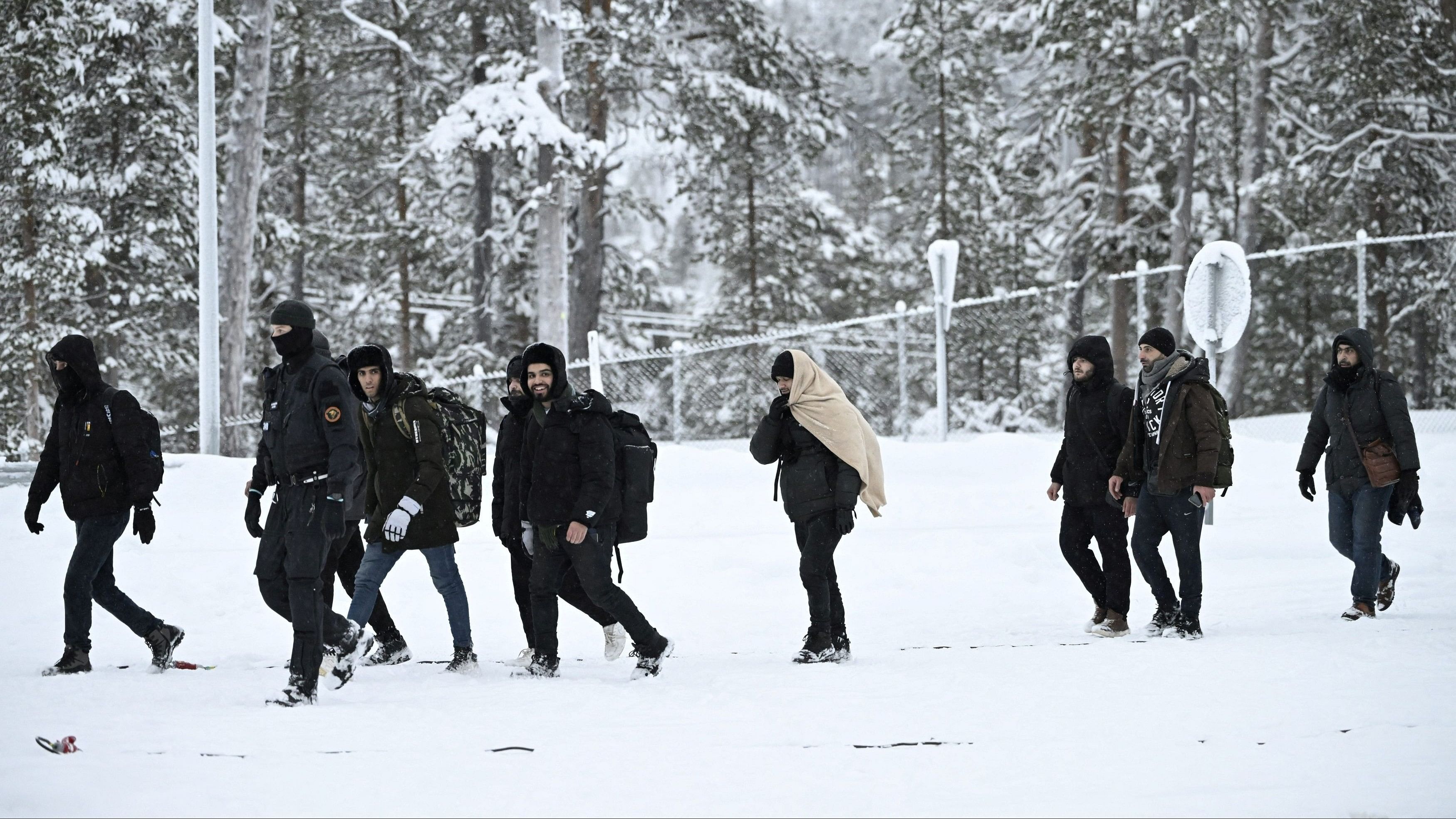 <div class="paragraphs"><p>Finnish Border Guards escort migrants arriving at the Raja-Jooseppi international border crossing station in Inari, Finland, November 25, 2023. Raja-Jooseppi in the far north of Finnish Lapland is the only crossing point open on the country's eastern border. Finland has closed seven checkpoints in response to Russian officials allowing increasing numbers of undocumented asylum seekers to pass through to the Finnish side of the border. </p></div>