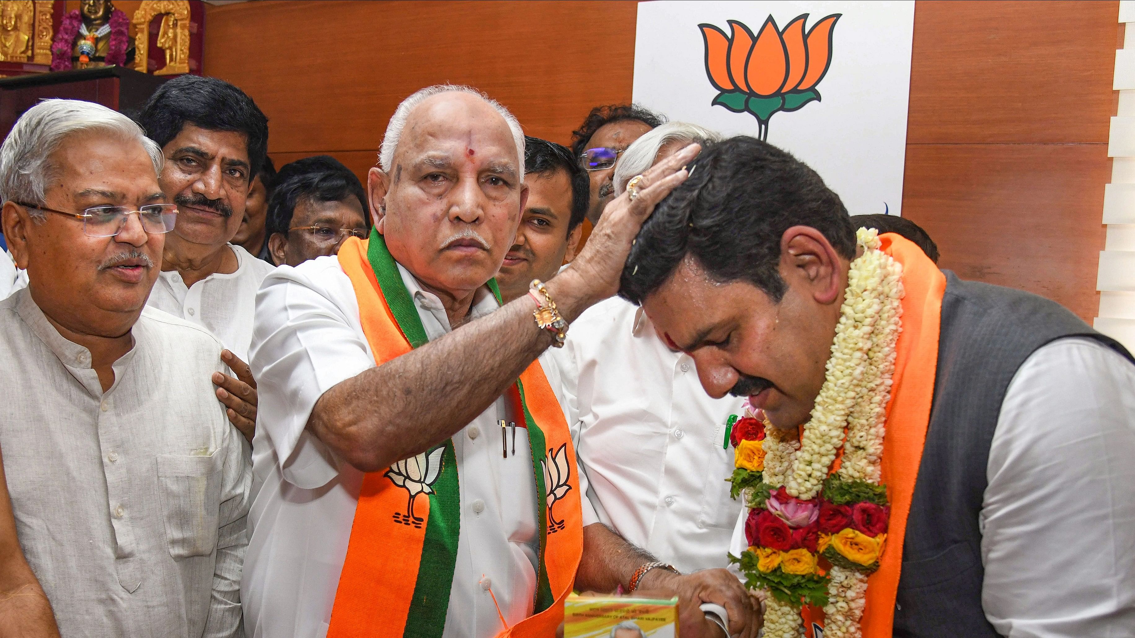 <div class="paragraphs"><p>Bengaluru: Newly-appointed Karnataka BJP president BY Vijayendra with his father and former chief minsiter BS Yediurappa during the charge-taking ceremony, at state party office, in Bengaluru, Wednesday, Nov. 15, 2023. </p></div>